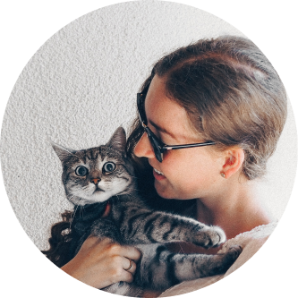 Women hugging a cat in her arms.
