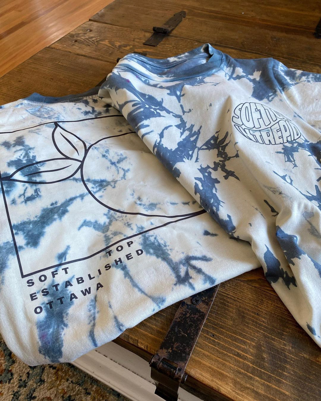 Real world application of the Soft Top Intrepid brand identity, screen printed for their official band merchandise.