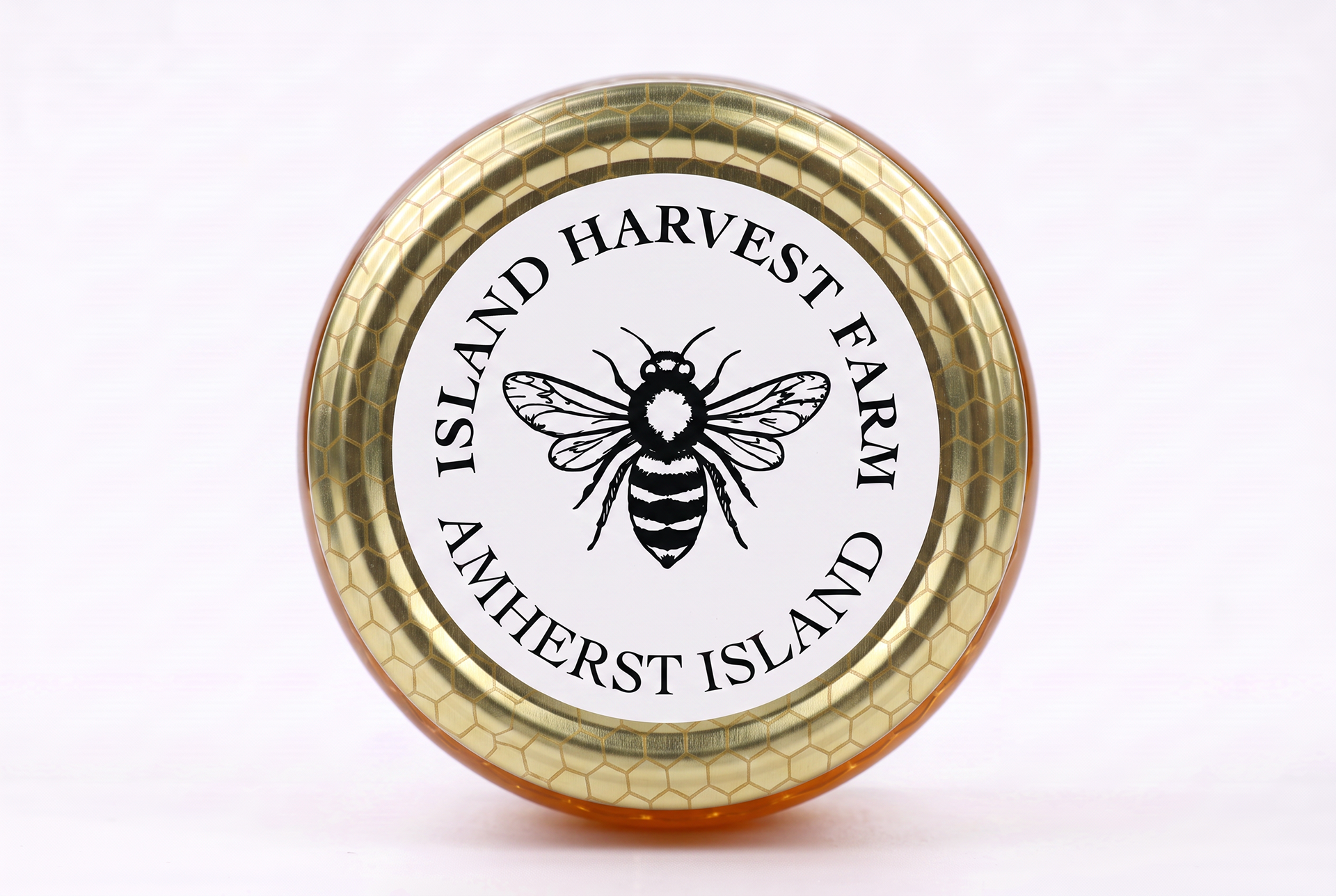 Mockup of the top-view of a honey jar with the sticker element added.