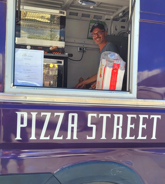 Pizza Street owner, George Siscos, at the window