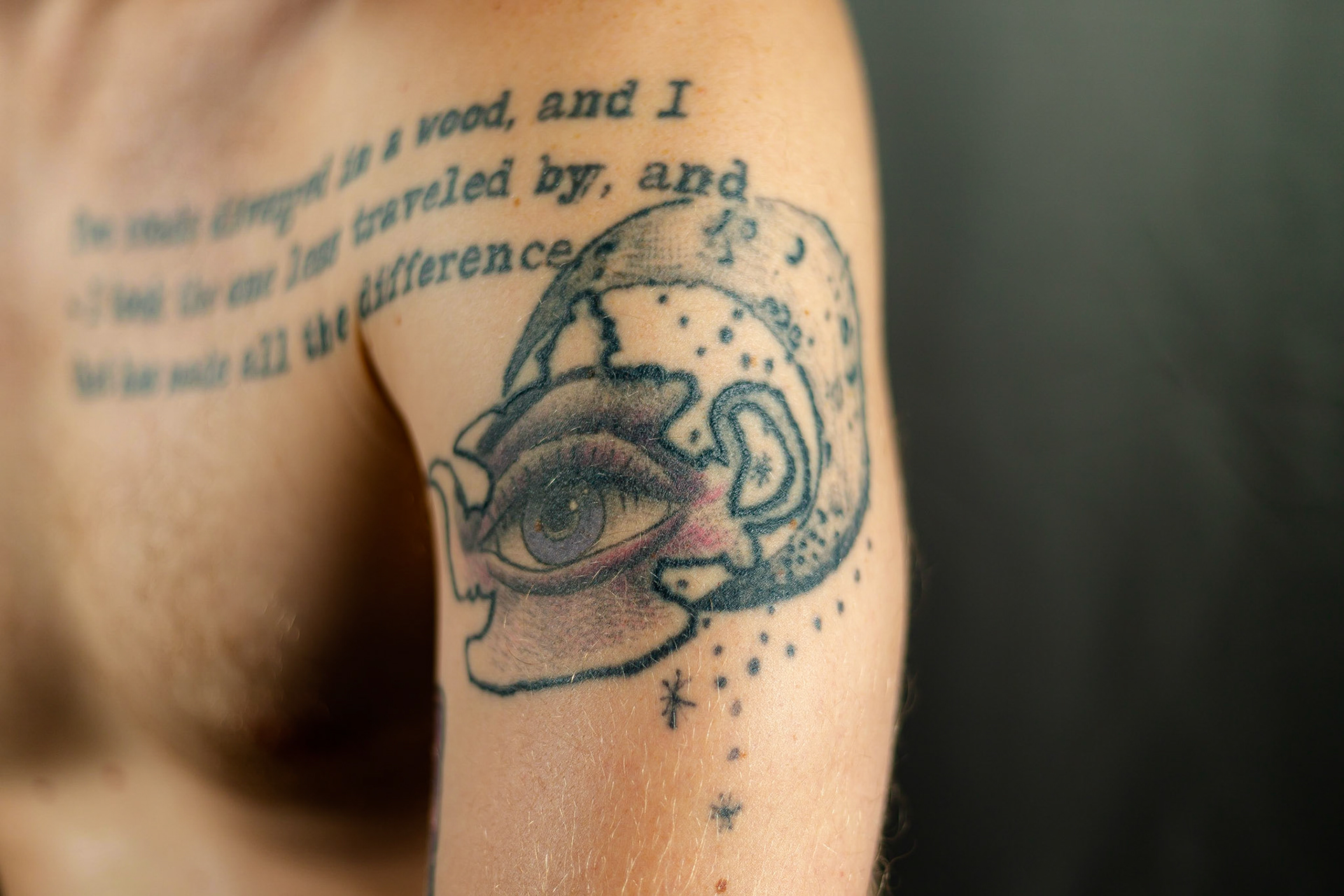On my shoulder: a moon in chains, and a tea kettle holding a purple eye. These are the two prime symbols of my biggest story.