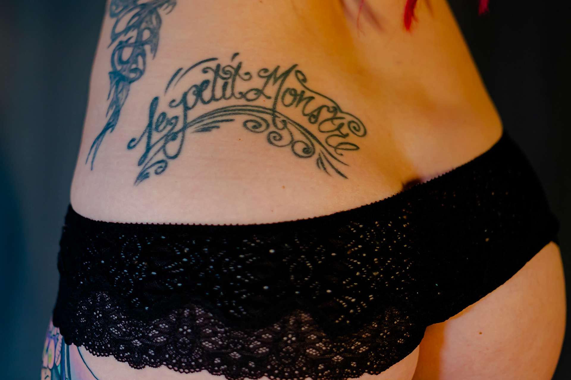 The French wording “ le petite monstre” on my left hip/upper butt translates to “the little monster”. I generally prefer an image to convey meaning rather than just spelling out what you want a tattoo to say. However, I’ve always found the French language beautiful and I wanted something French on my body. I was an extremely competitive athlete in high school, plus I was the awkward goth girl. I was teased in school by being called a “monster” in the athletic/competitive sense but also because people assumed that because I dressed more alternative, I must like witchcraft or worship Satan (eyeroll, I’m actually Christian).