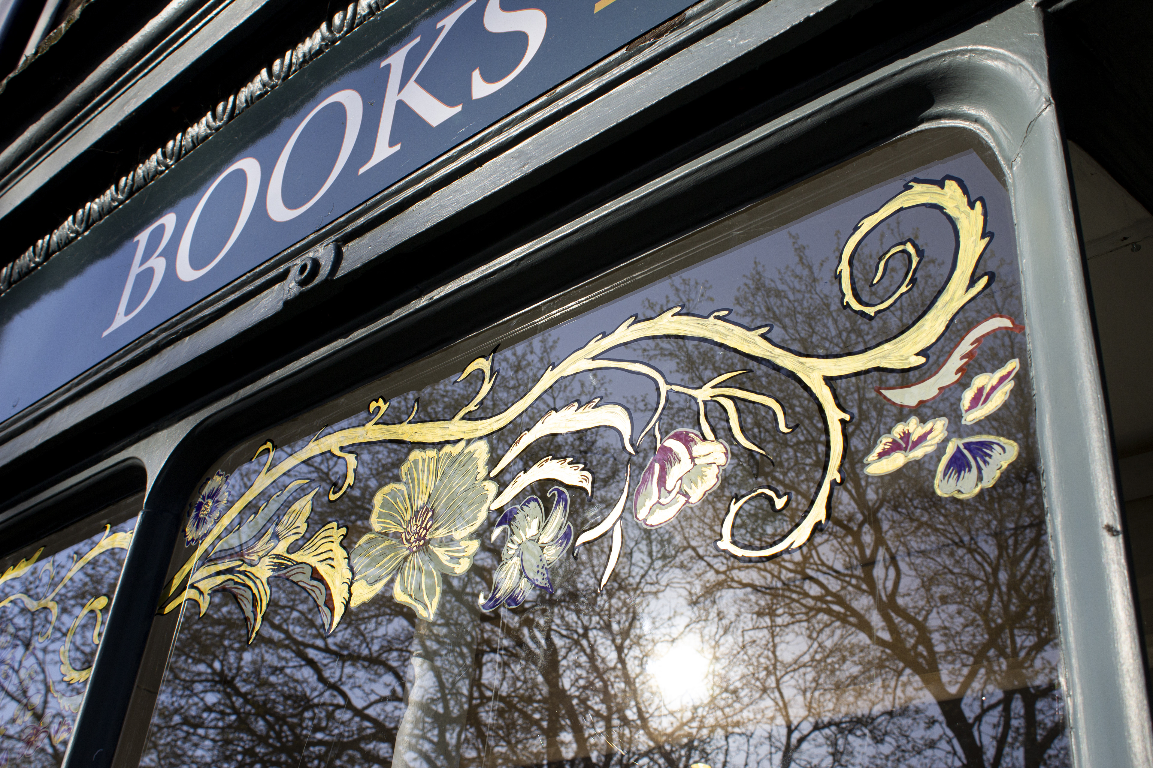 Hand Painted Bespoke Window Art Mural Designed to tell your brand story, whether through decorative motifs or your brand story visualised, - For Bookshop windows, Café Murals, Shop Window Designs, and all Business Facades