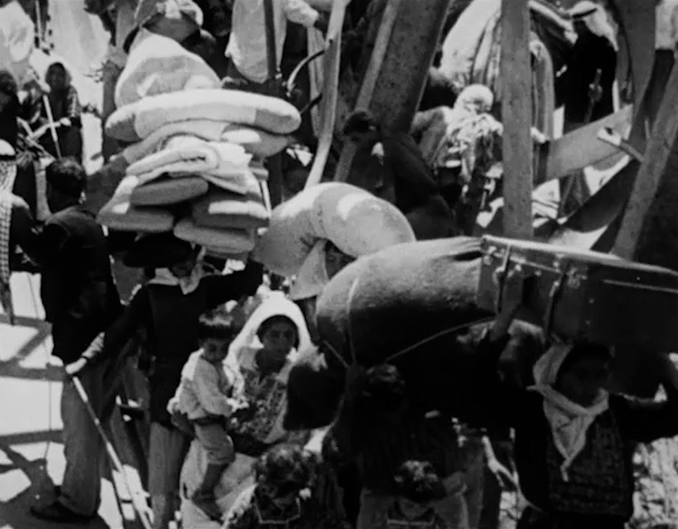 An archive footage of 1948 diaspora and Nakba. In this frame Palestinians cross the bridge to the East from fleeing Palestine to Jordan