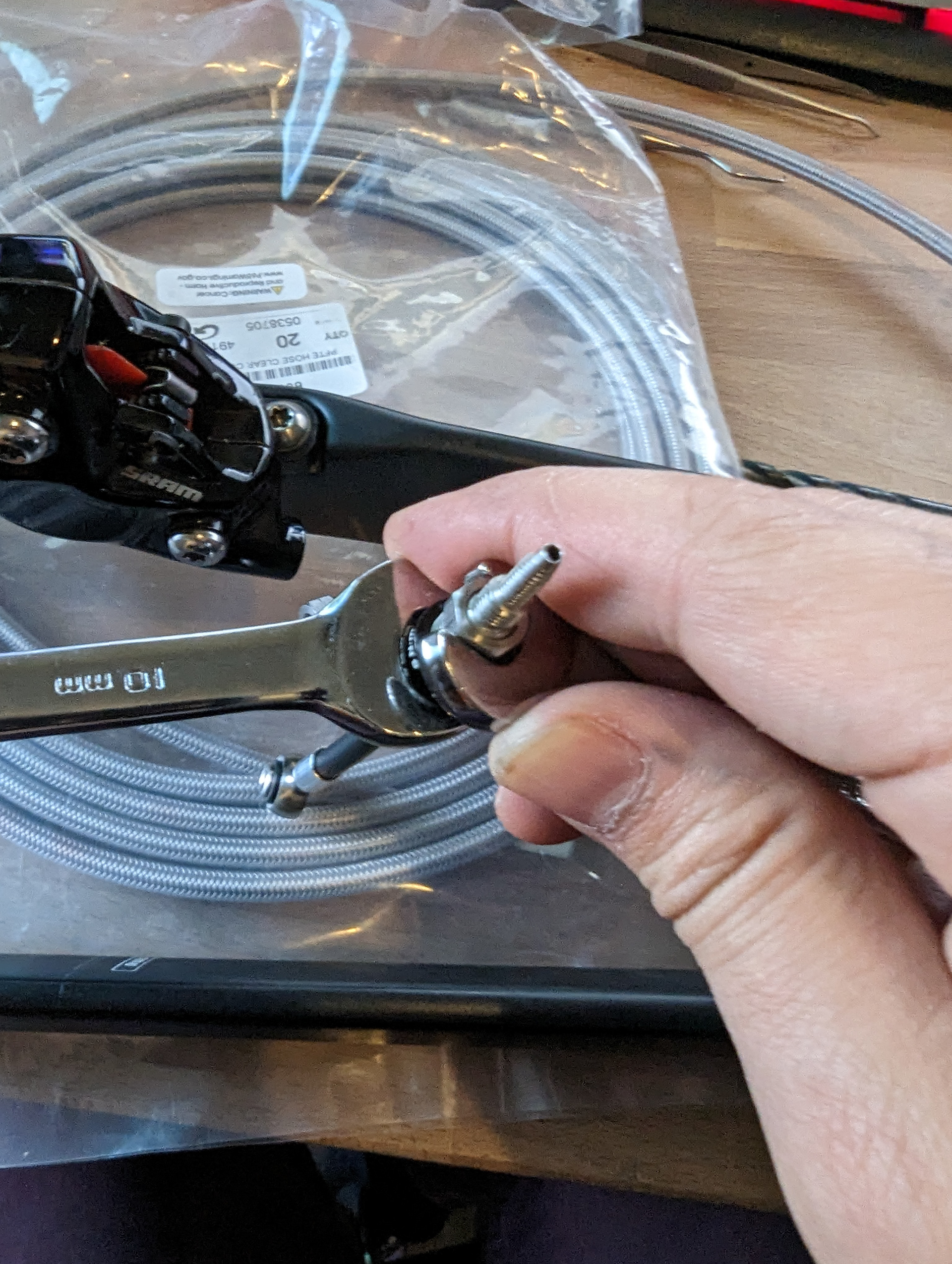Tighten the swivel connector into the spare hydraulic lead