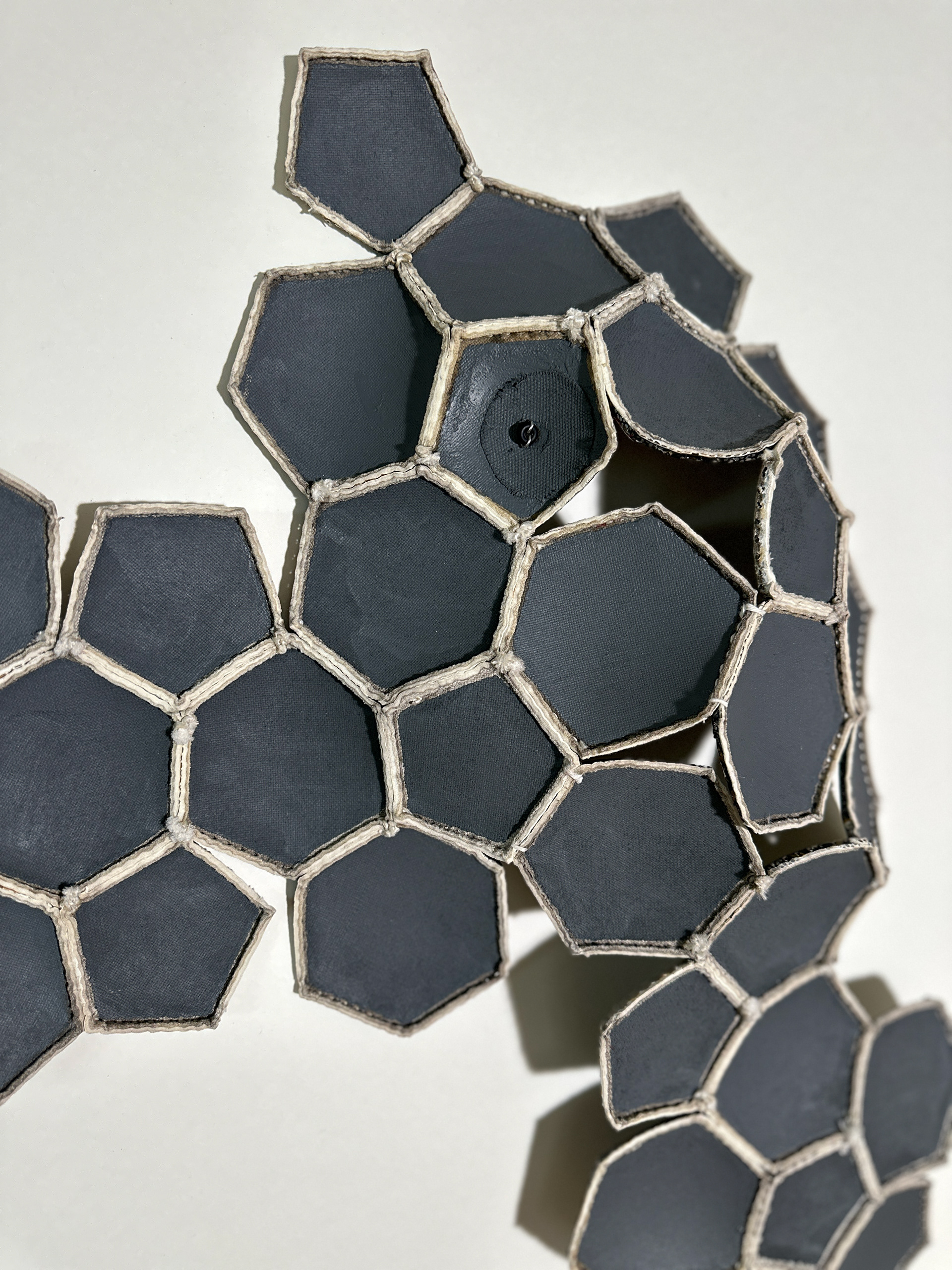 Tessellation #7, dysected soccer ball, thread, new seams added, acrylic paint