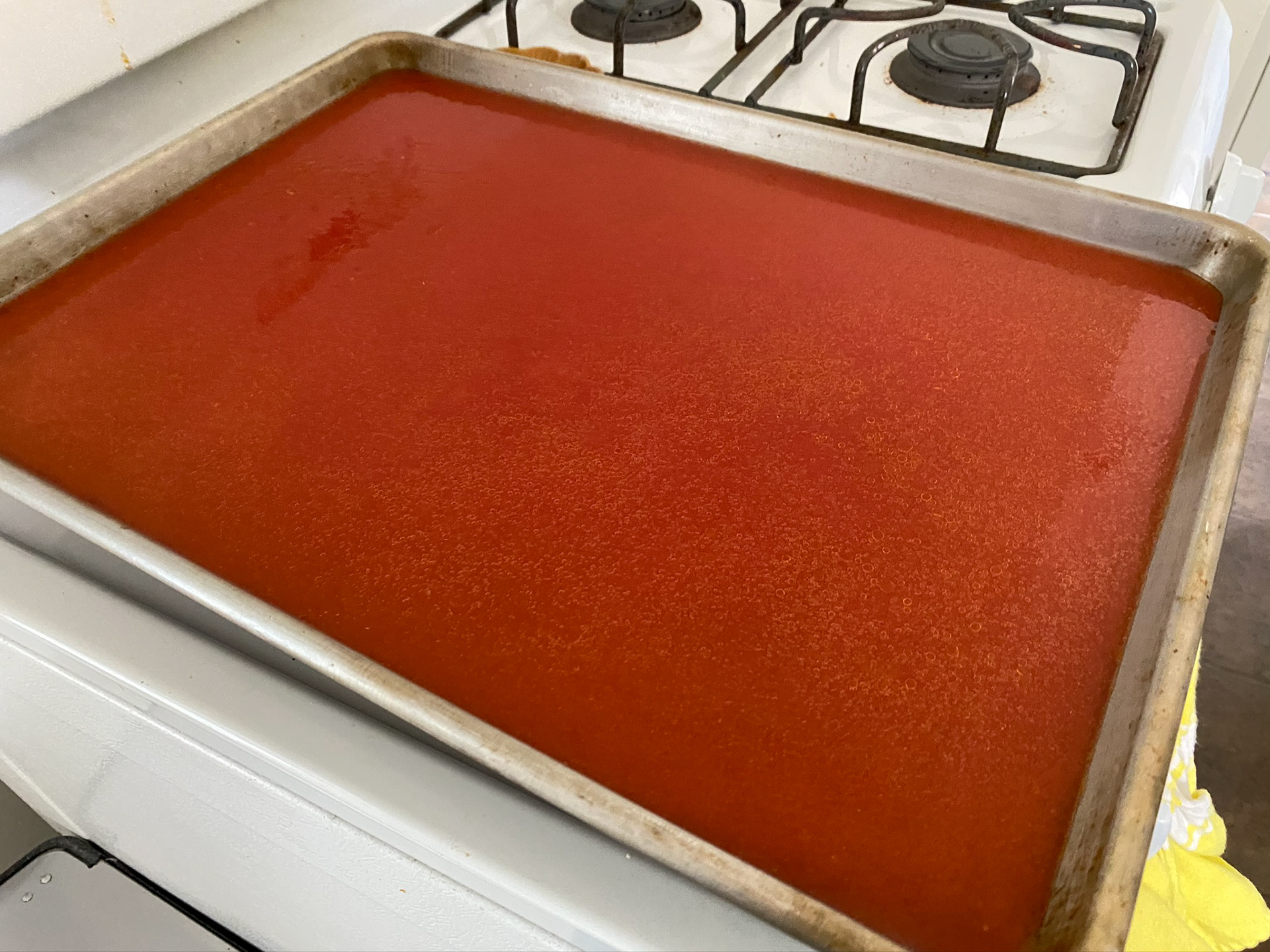 Pour the liquid tomato juice that was extracted into a sheet pan and bake at 300 degrees