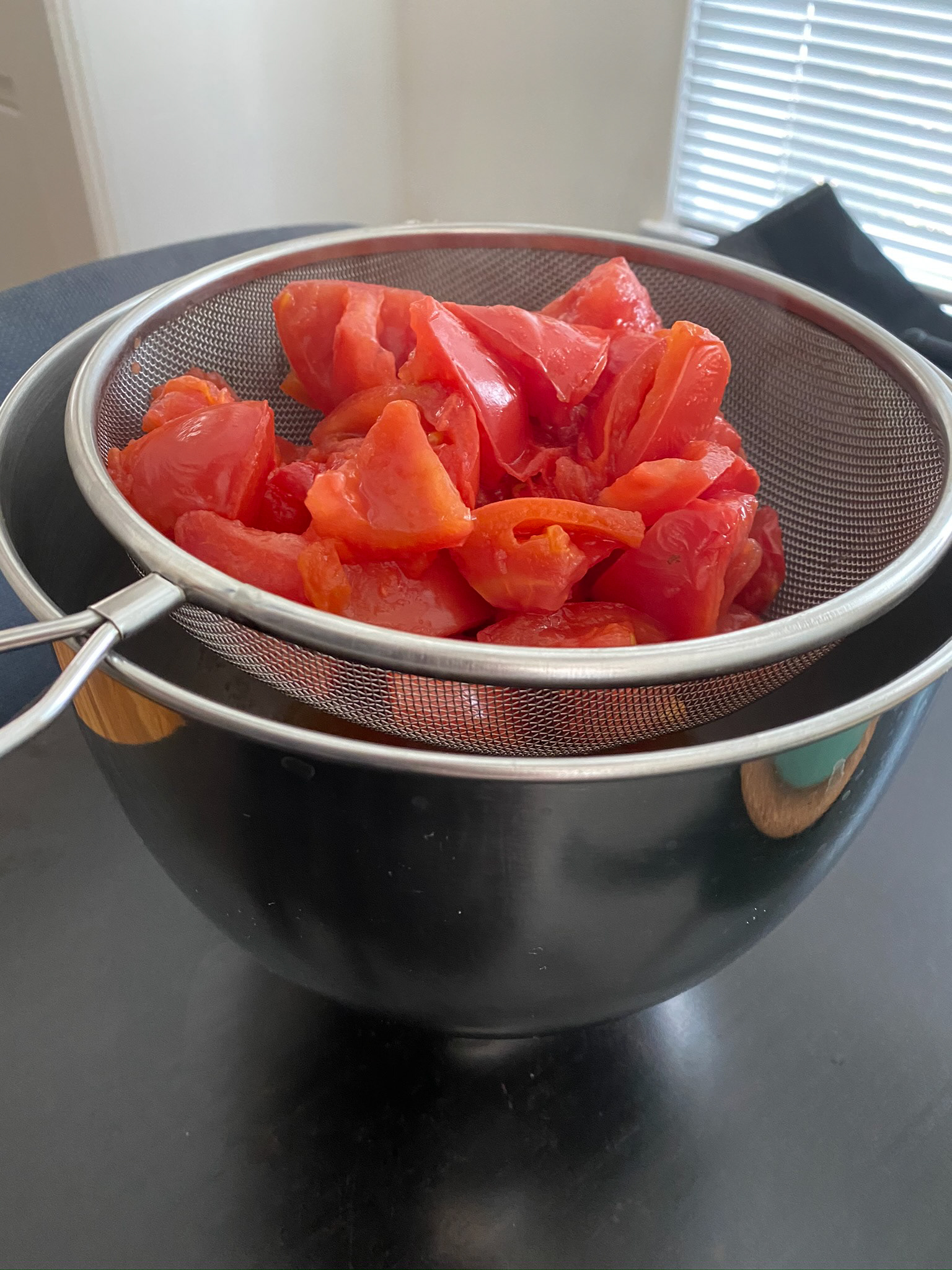 Put into collander or food mill to separate the skin and remaining seeds from pulp