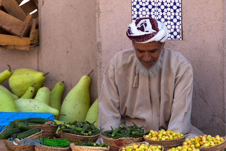 Vegetable seller at a market in Oman
