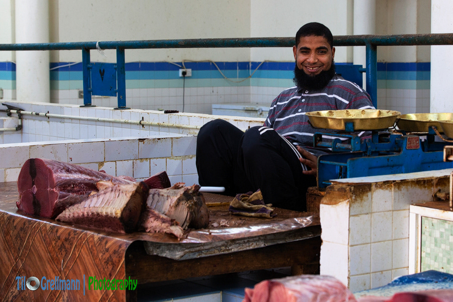 Fishmonger at a market in Oman