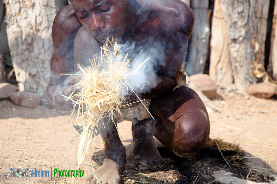 Man from the Damara people lighting a fire