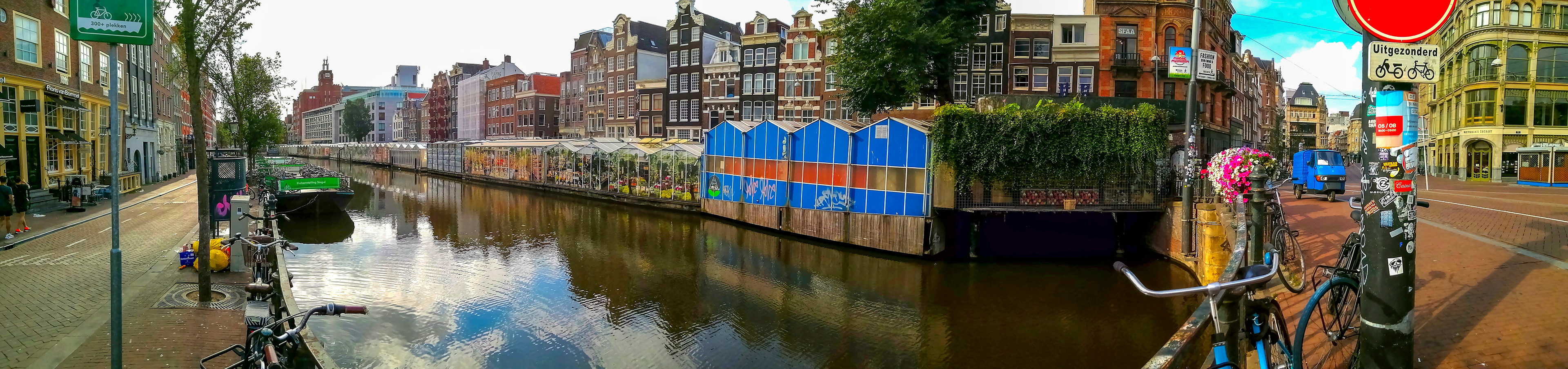 Row of tents along the canal is the Flower Market, Amsterdam.