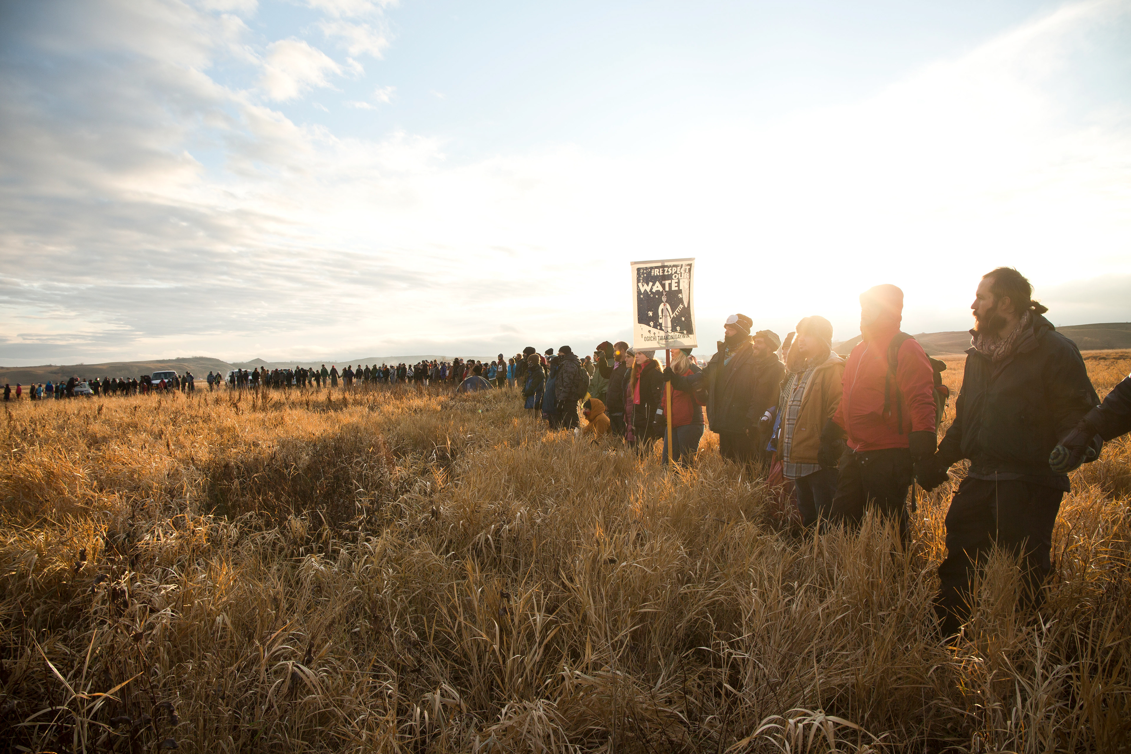 Thousands gather at the base of the burial mound at sunset to pray.