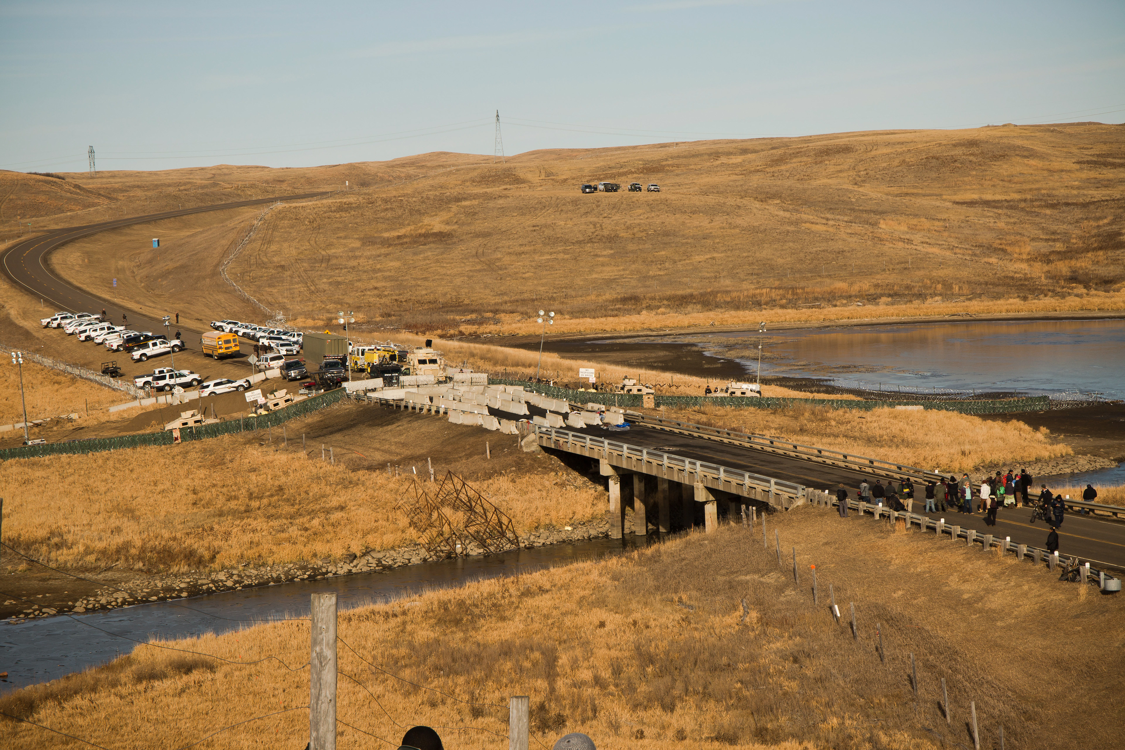 Militarized police block 1806 highway, the most direct route to Oceti Sakowin camp. Days before, water protectors were sprayed with water cannons and rubber bullets in freezing temperatures during a night-time stand-off.