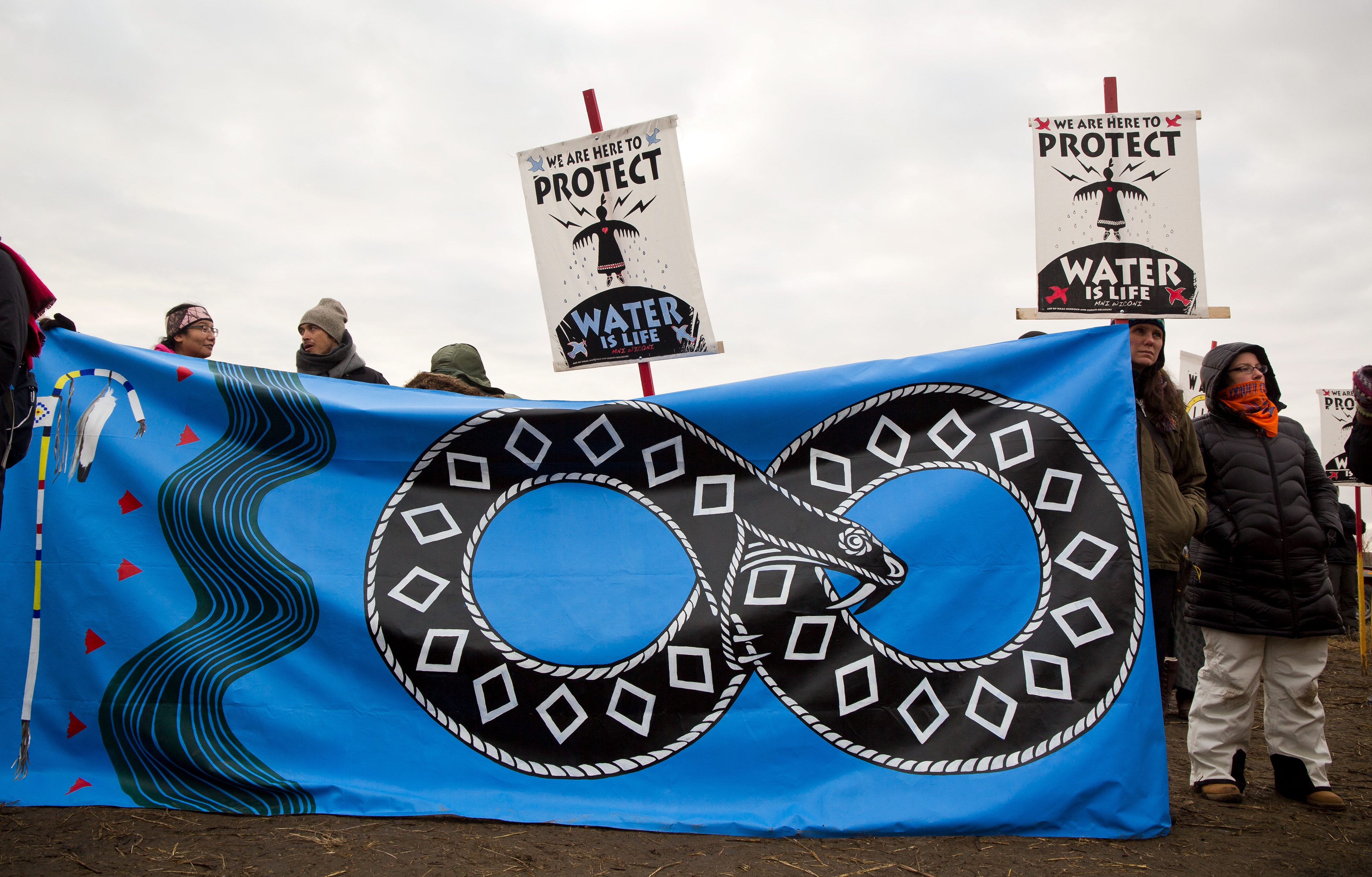 Protest flags bear the "black snake" the Native American prophecy of destructive pipelines like DAPL.