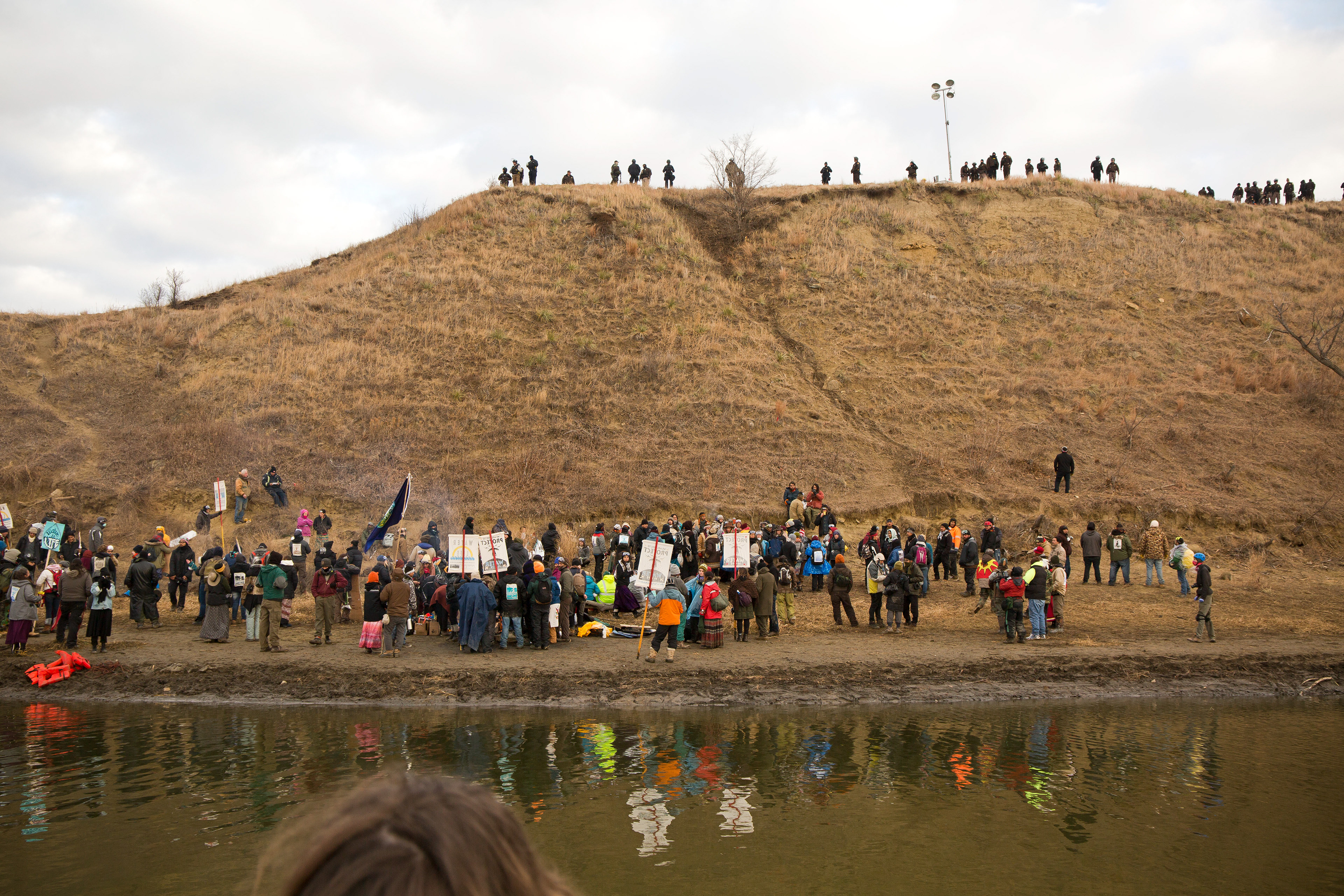 Water protectors chanted: “Remove yourself from the graves of our ancestors. We are here in love. We are here in peace. We are here for our ancestors.”