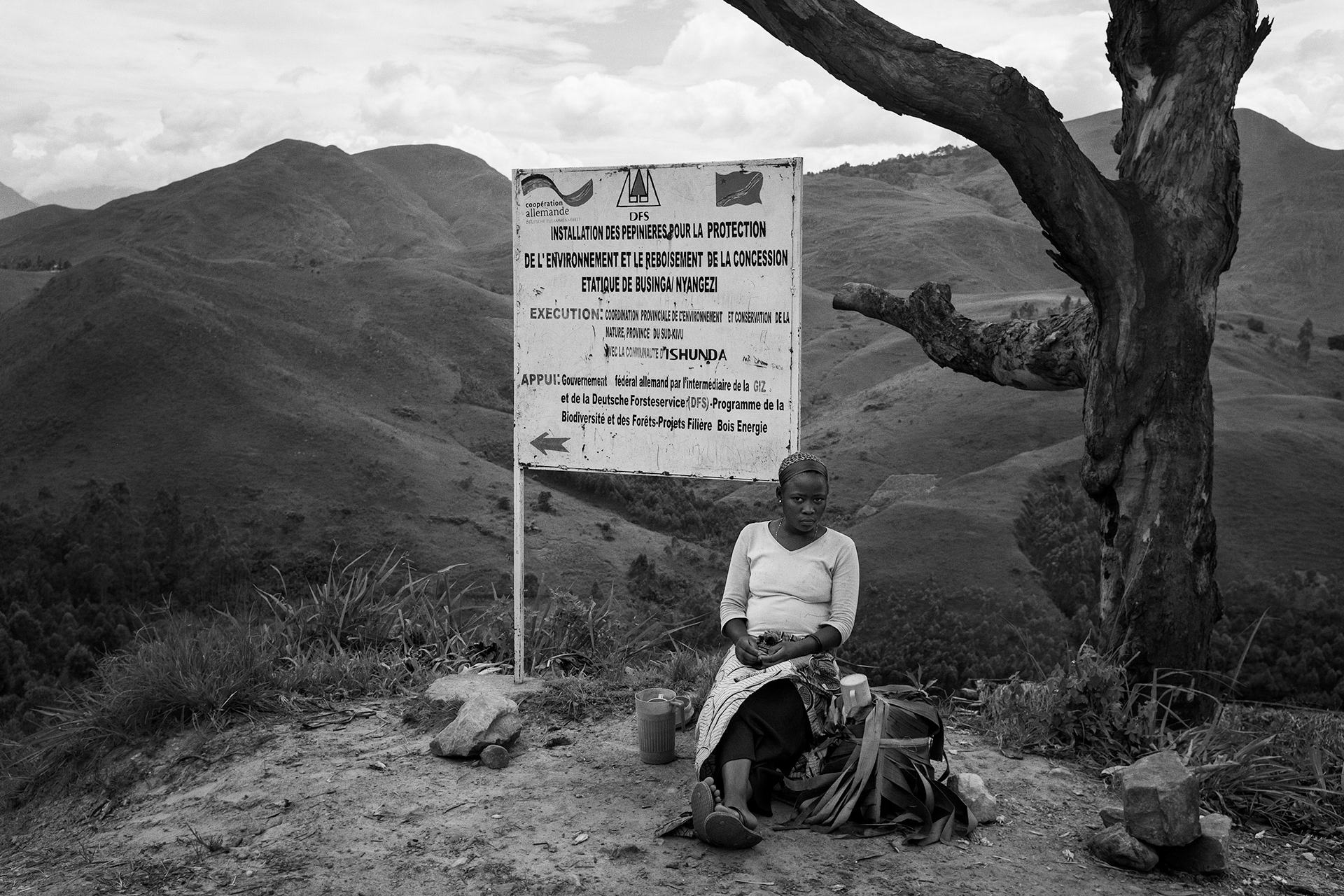 South-Kivu, March 2016. Advertisement board for a reforestation project funded by the GIZ (the German international cooperation agency) on a landscape that was, before the sixties, fully covered with forests. Conflicts in this region neighboring Rwanda and Burundi led to massive displacements of population, which rely on wood for construction and domestic use. Now, severe landslides often hit this area where large portions of hills are clear-cut.