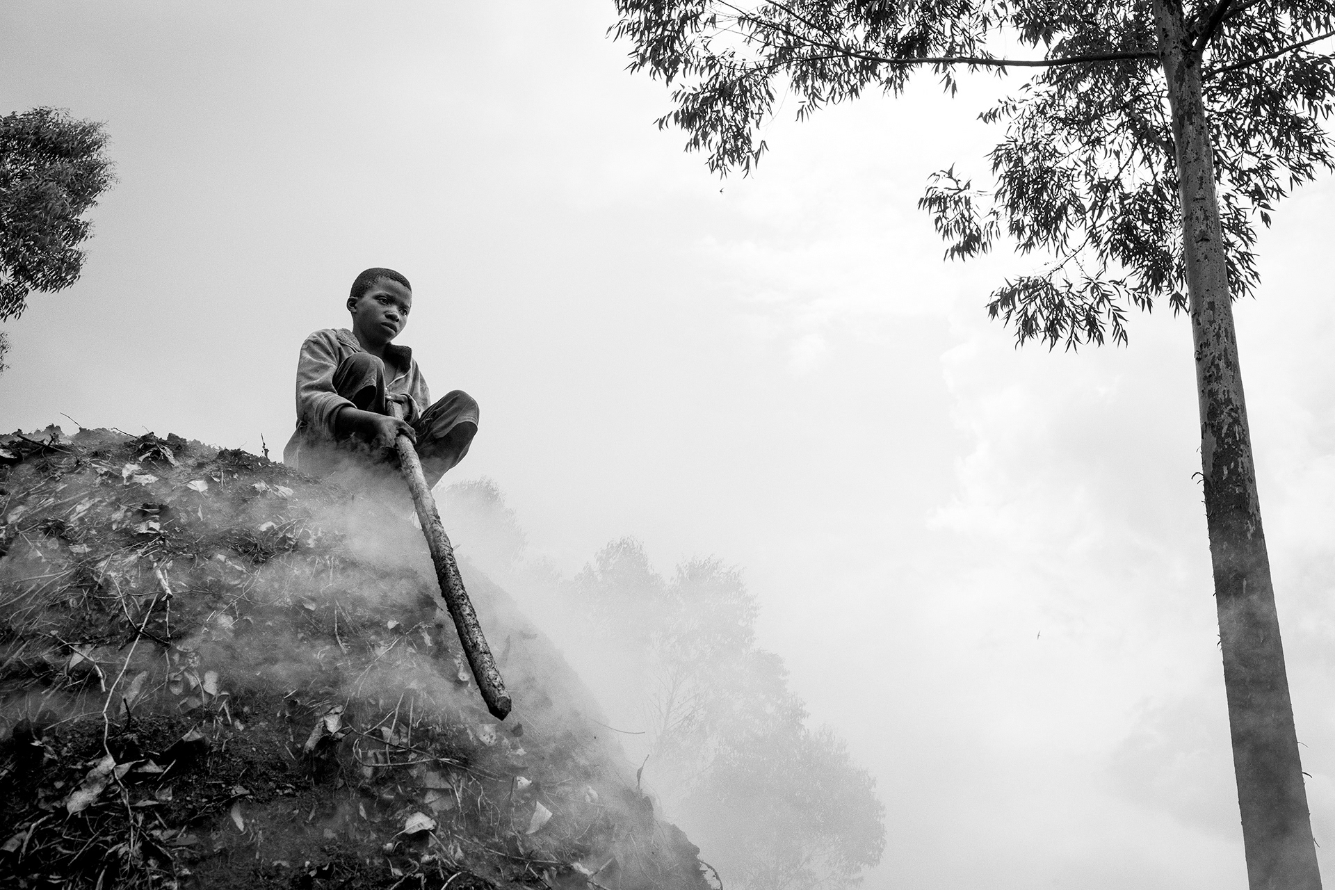 Kanyanja, North-Kivu, March 2016. Yoshuera Kajeri is seen on a makala (the name in Swahili for charcoal) oven, used to char wood. With an electrification rate of only 10% charcoal remains the main source of domestic energy.