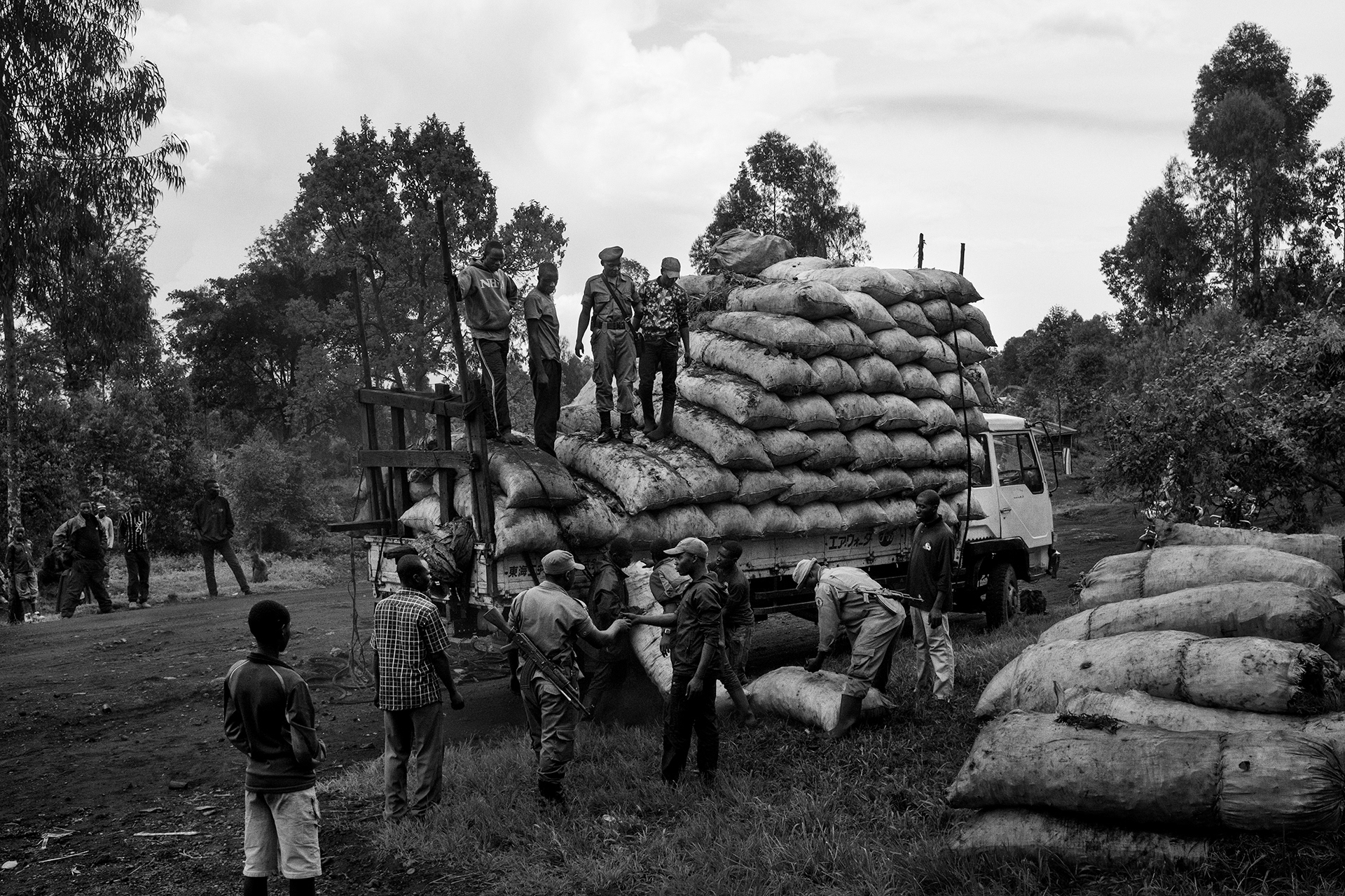 North-Kivu, November 2016. Park rangers from the Congolese Institute for Nature Conservation (ICCN) inspect a truck loaded with bags of makala nearby the Virunga National Park. While ICCN tries to halt illegal charcoal production in the park, it remains among the top economic sectors in the area and is used as revenue by armed groups to fuel local conflicts.
