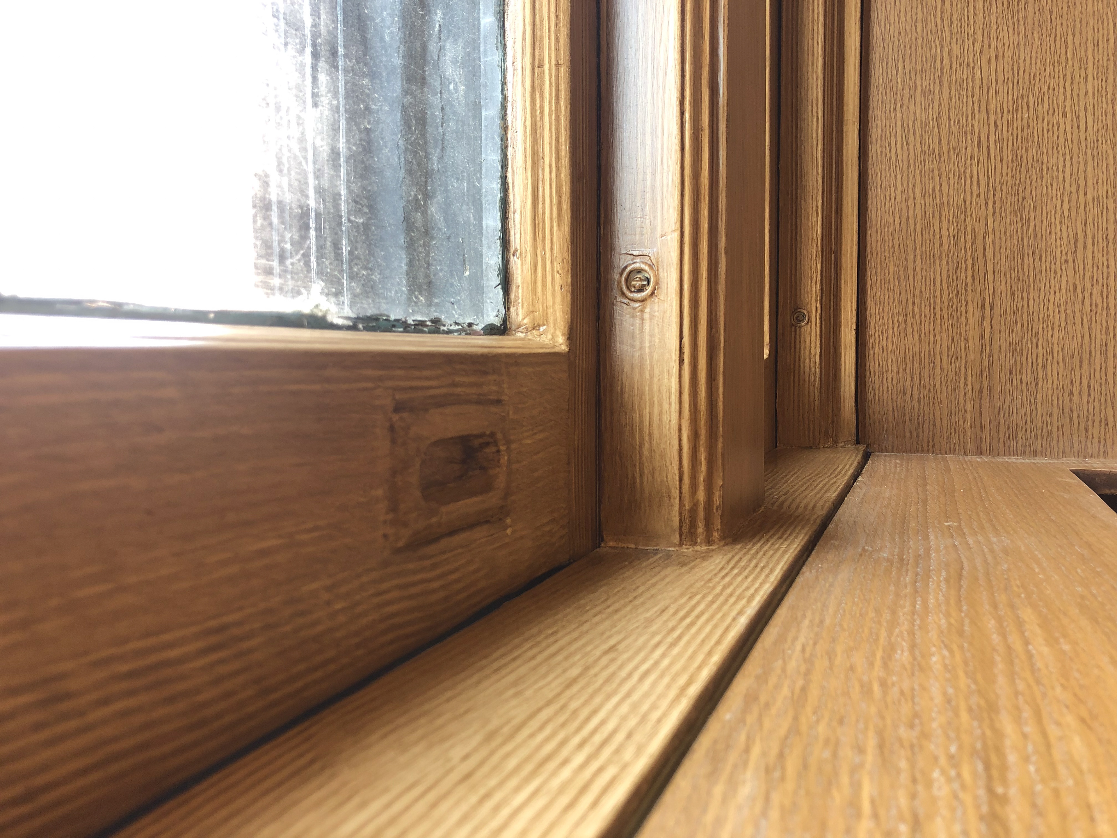 Window frame grained to match surrounding wood veneer