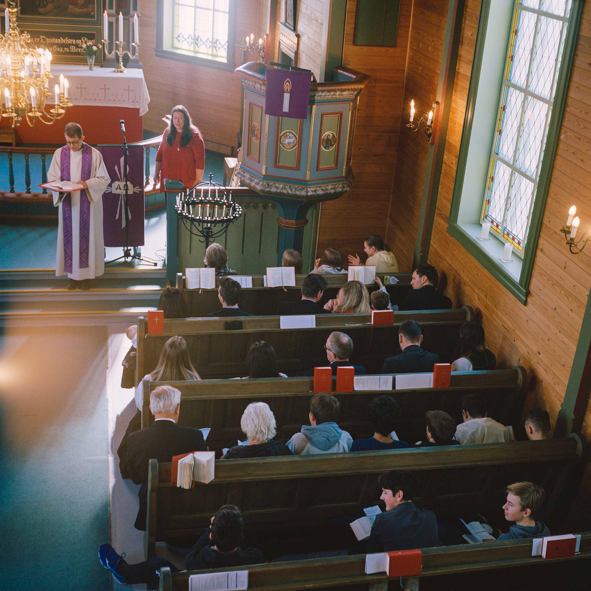 The parish priest, Geir Øy, sings a hymn in Alversund church with the assistance of Helle Kartveit, who is the church’s catechist and confirmation leader.