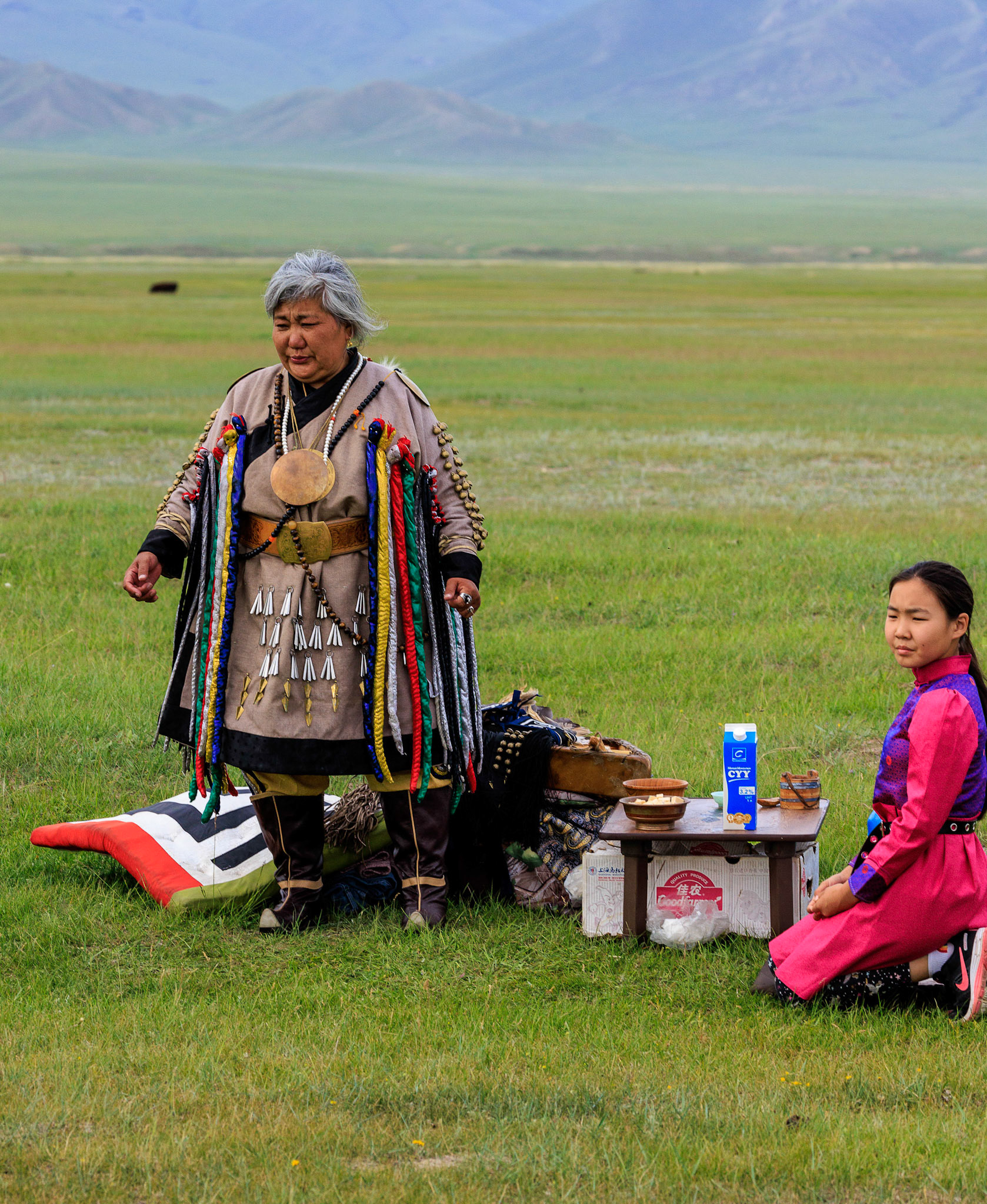 Mongolian Female Shaman and assistant preparing for spiritial encounter