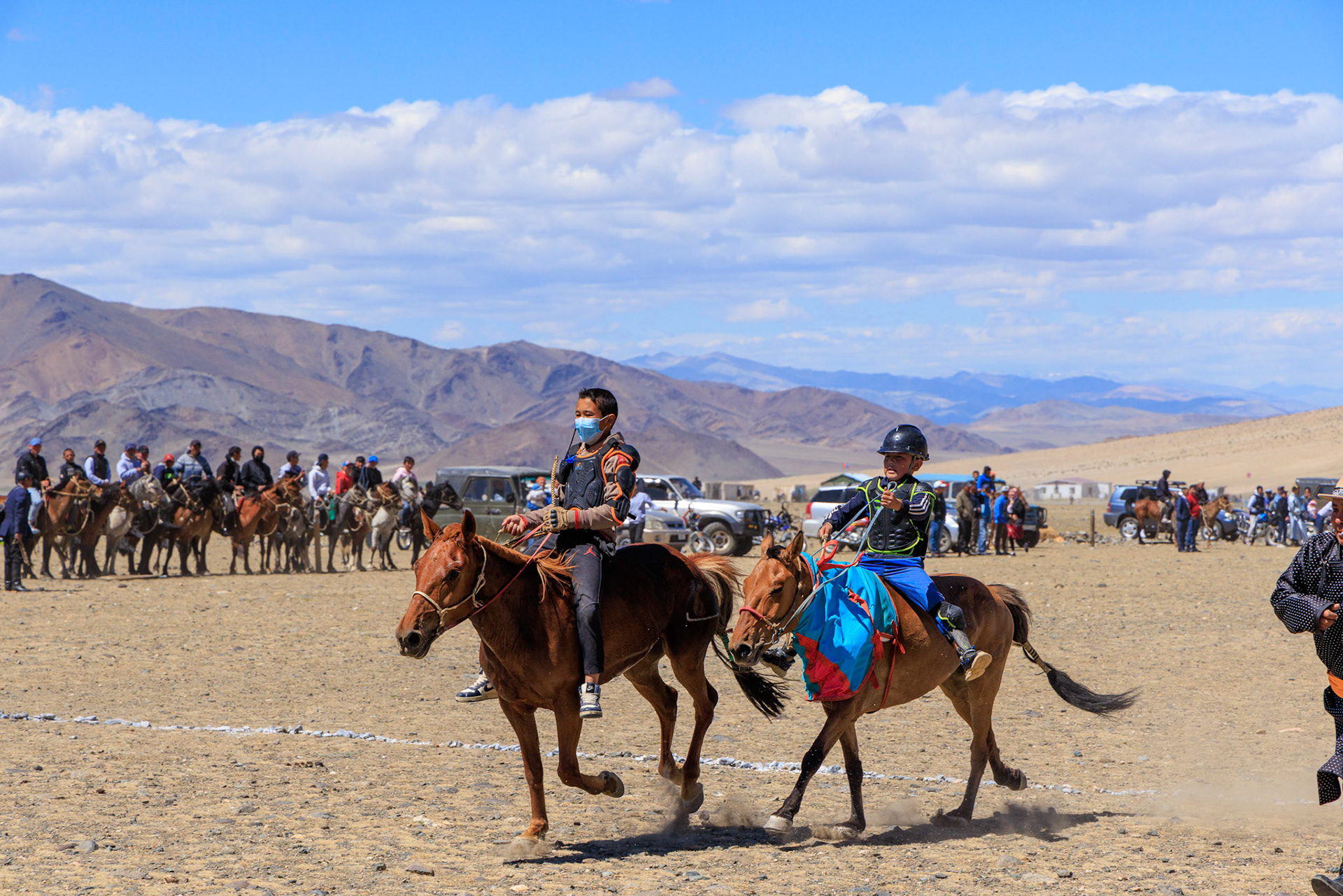 They race long distances, not around a track. The mask is protection from the dust