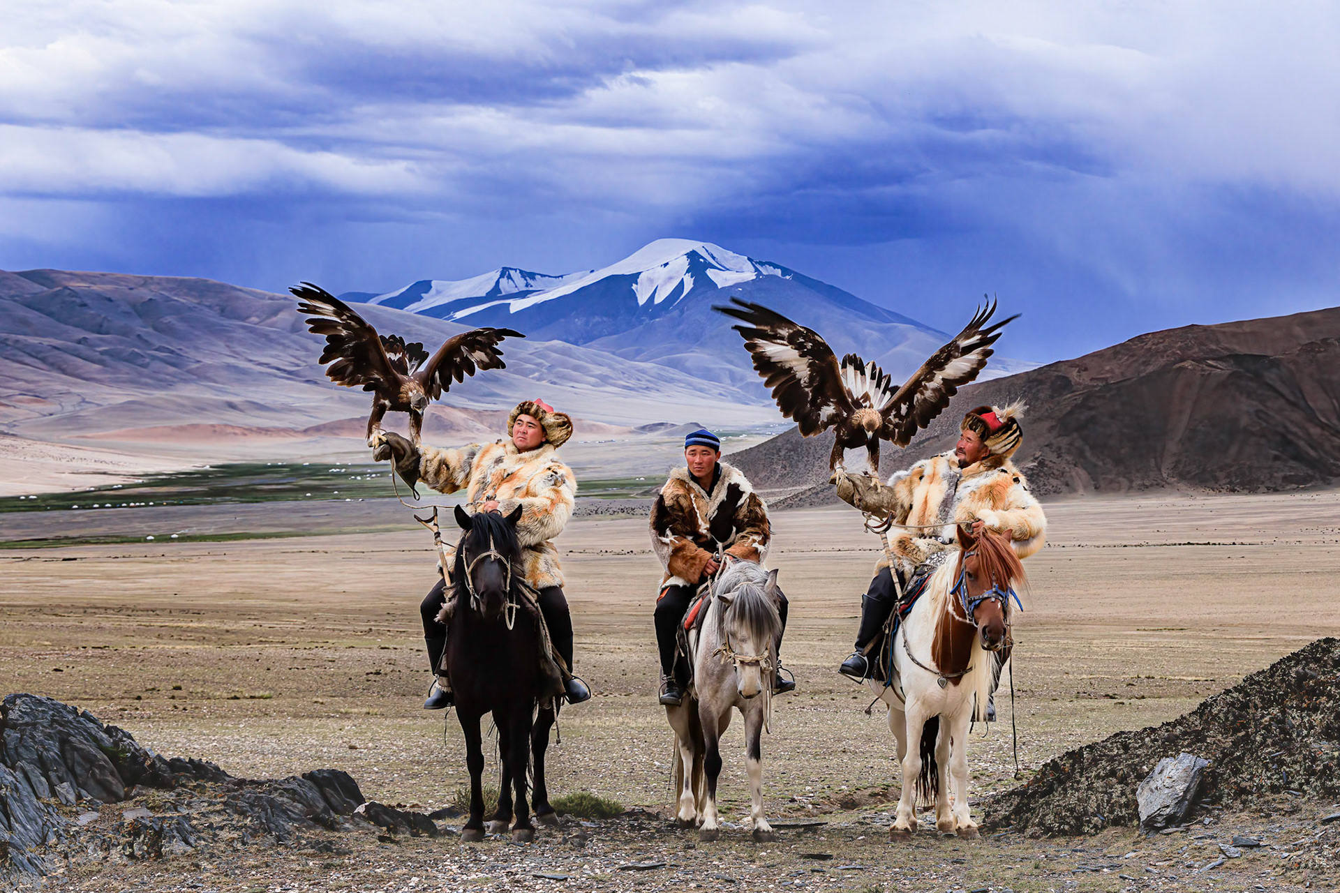 Kazakh Eagle Hunters Serikjan and Sailua with their Golden Eagles
