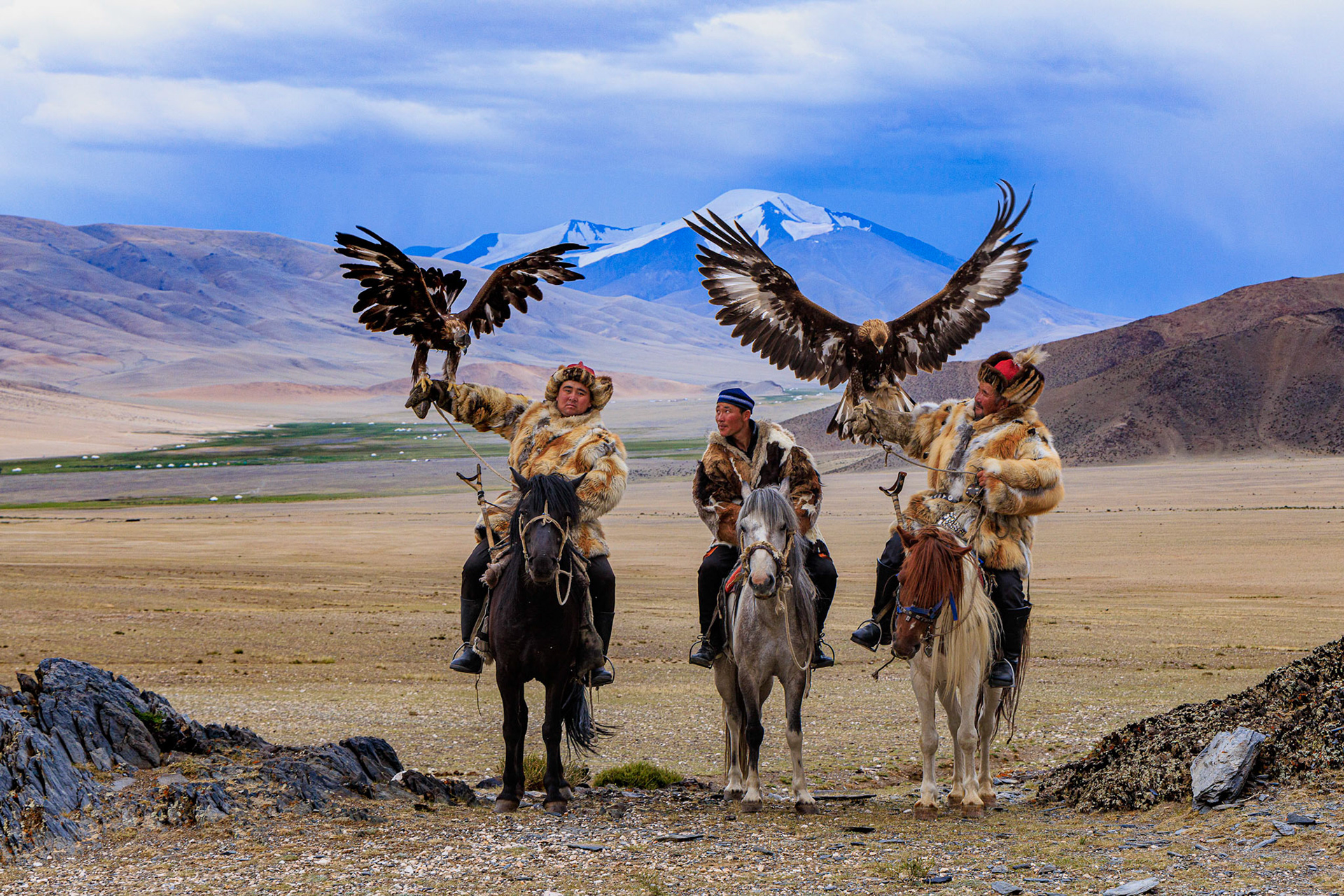 Kazakh Eagle Hunters Serikjan and Sailua with their Golden Eagles