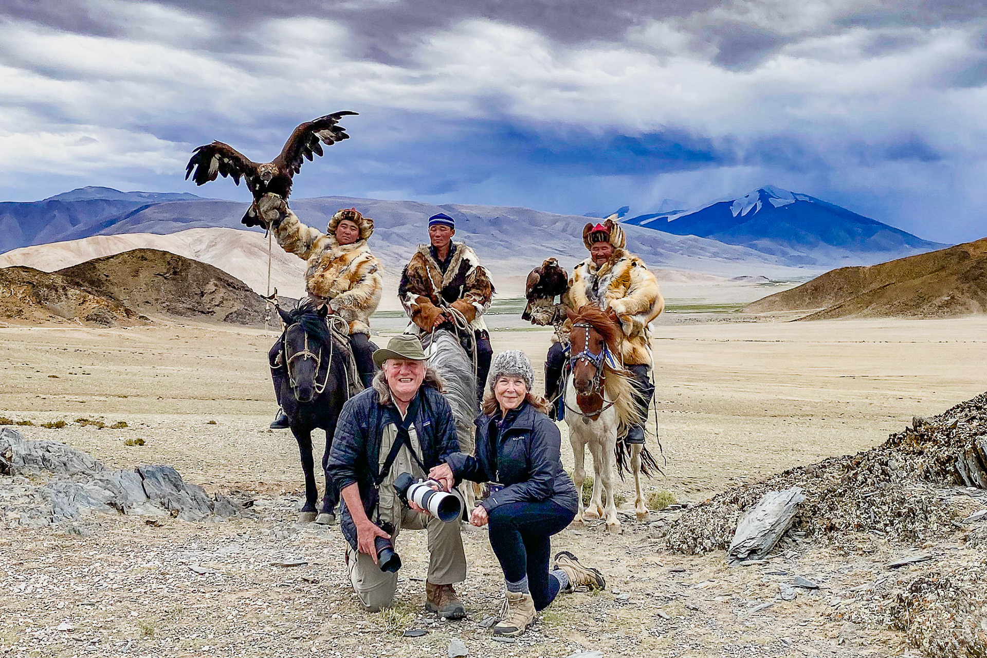 Kazakh Eagle Hunters Serikjan and Sailua with their Golden Eagles. Ken and Susan documenting the experience