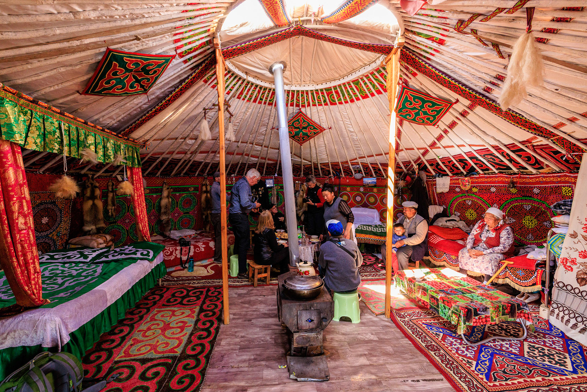 We are invited for tea. Entertaining at back of Ger. Left men, right women, back honored guests is standard Mongolian Ger layout.