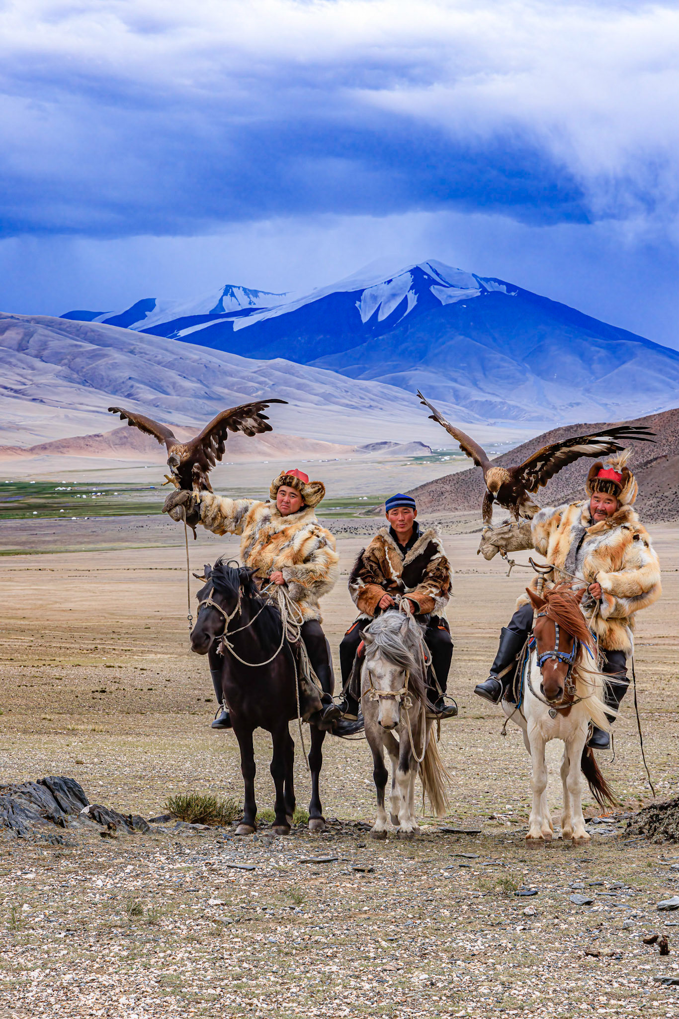 Kazakh Eagle Hunters Serikjan and Sailua with their Golden Eaglesailua