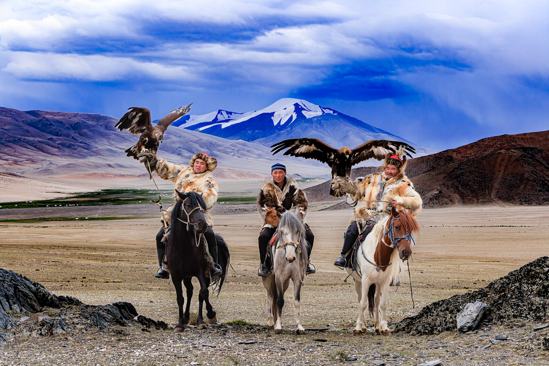 Kazakh Eagle Hunters Serikjan and Sailua with their Golden Eagles