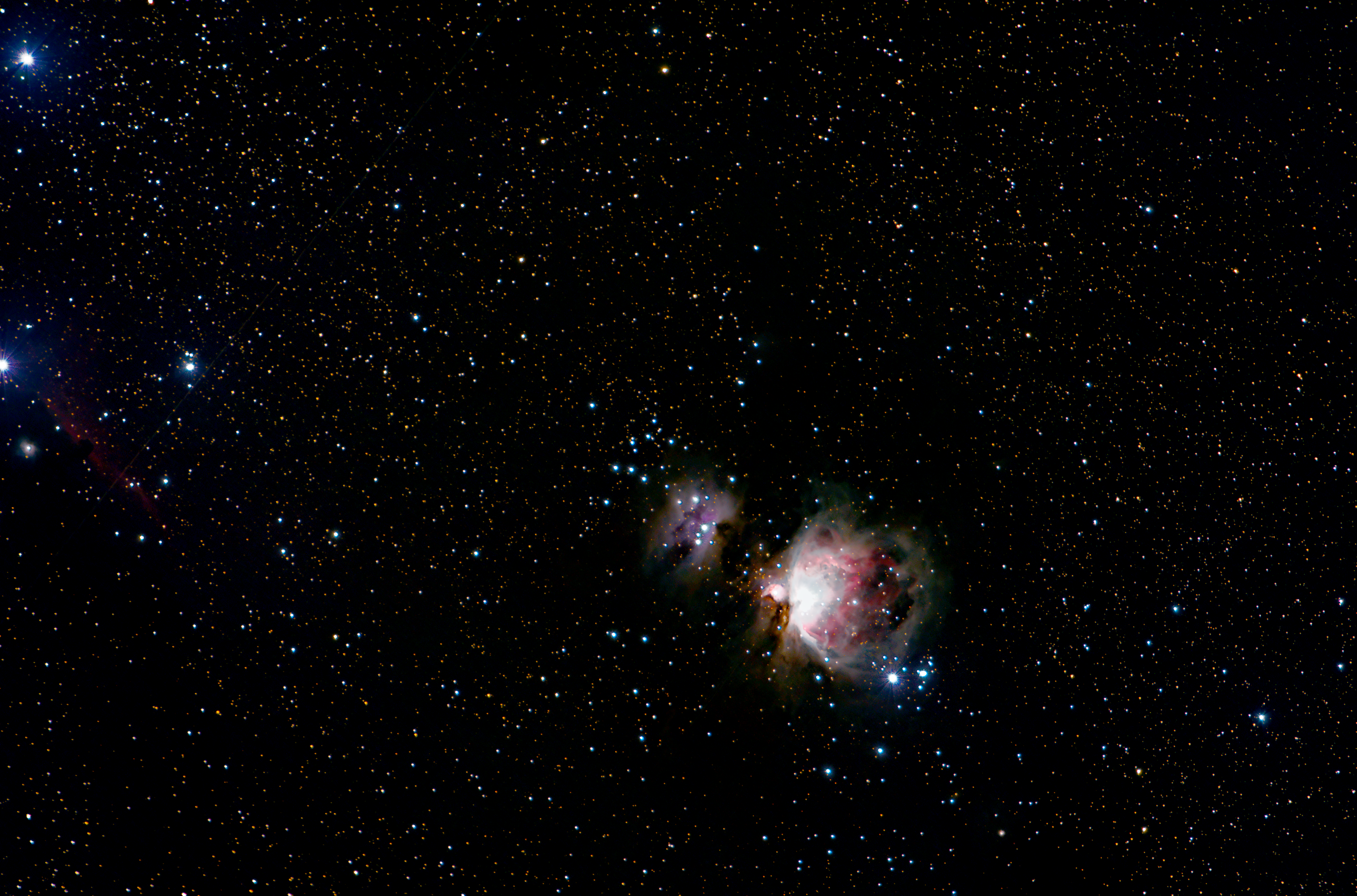 The Orion Nebula steals the spotlight from its fainter neighbor, the Running Man Nebula.