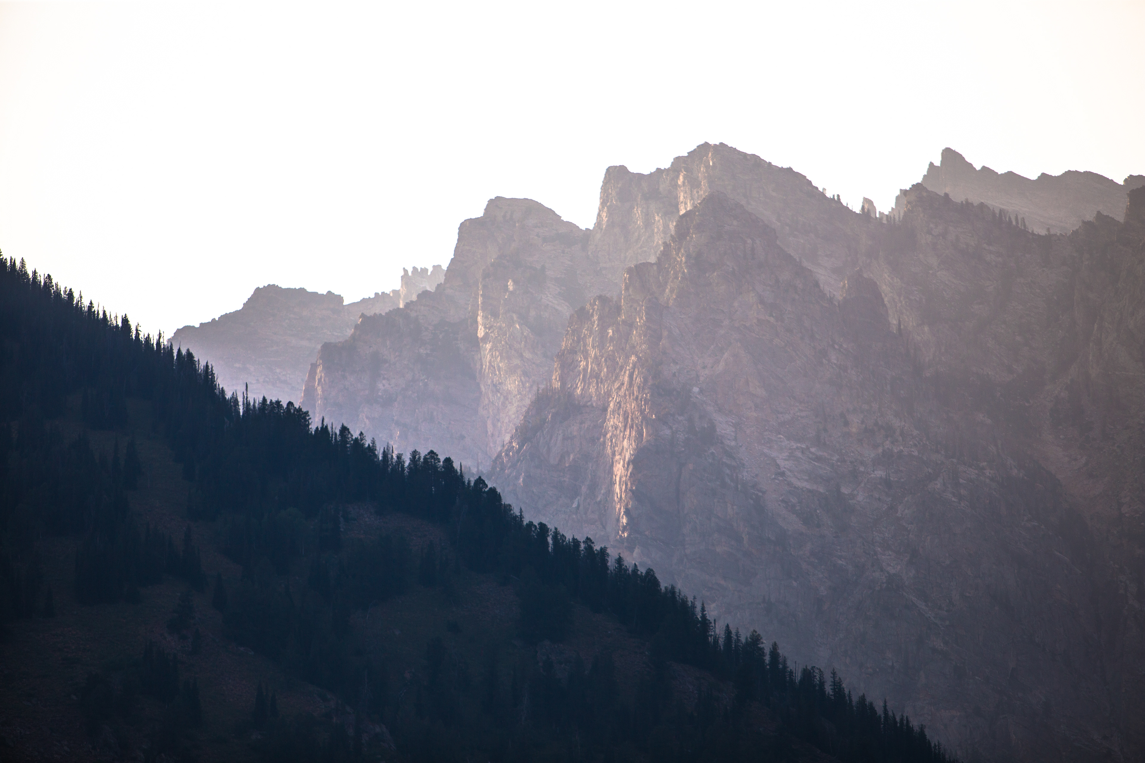 The Grand Tetons rise above the foreground to catch what remains of the setting sun.