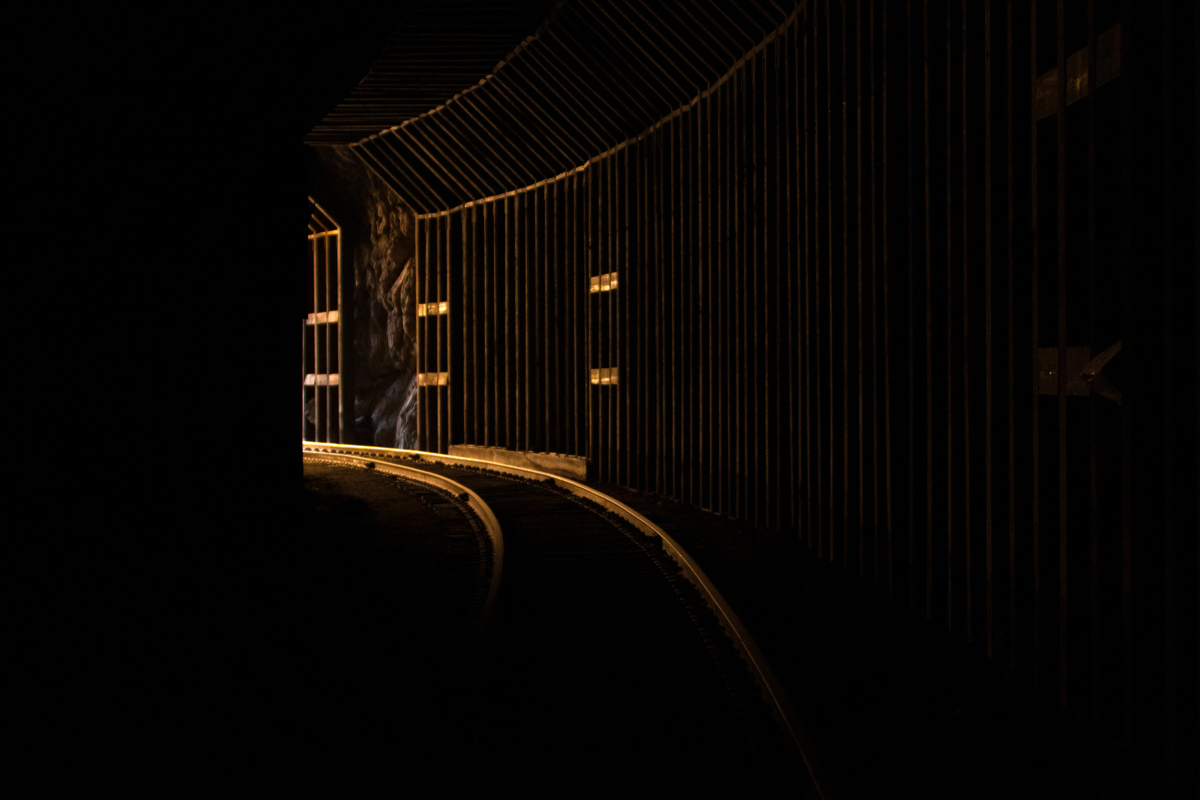 A soft orange glow makes its way into an abandoned trail tunnel in the Southern California desert.