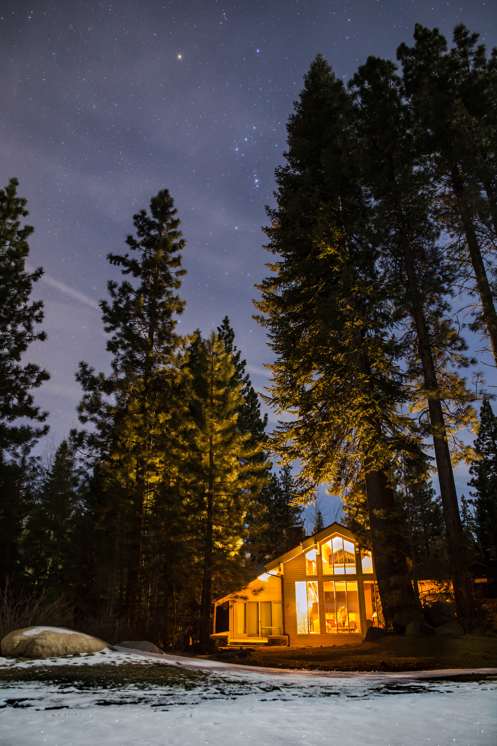 Orion's Belt watches over a gently lit winter cabin in Incline Village, NV.