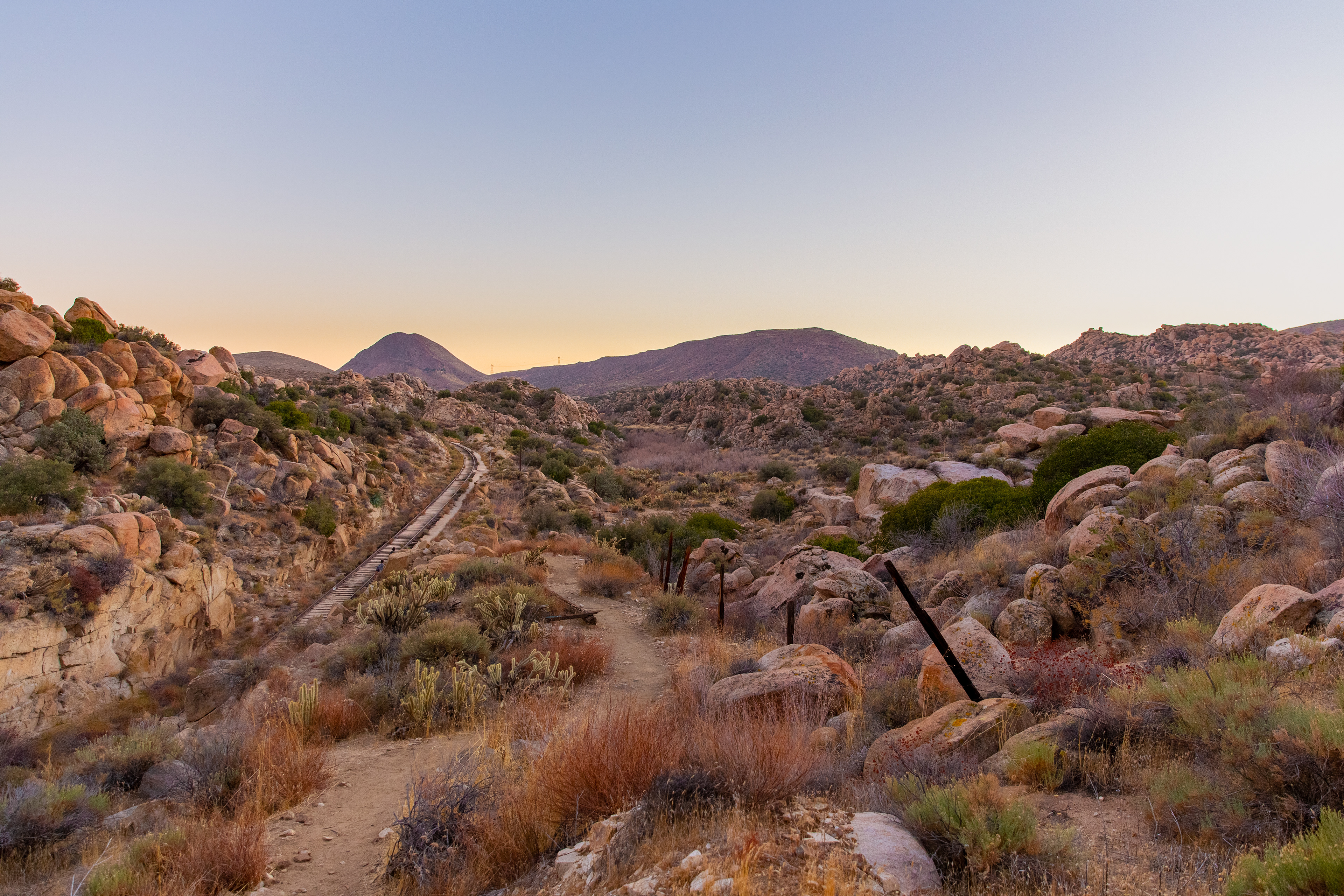 The setting sun lends its last light to the landscape around this abandoned railroad.