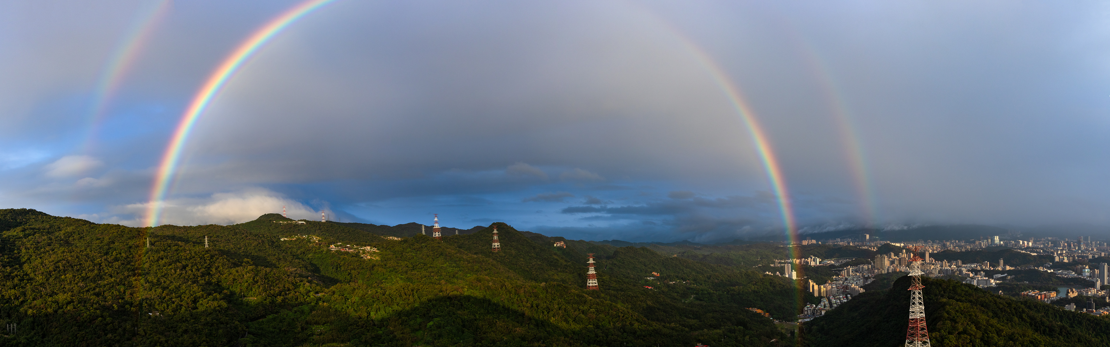 A double rainbow follows a rainstorm over this landscape in Taiwan.