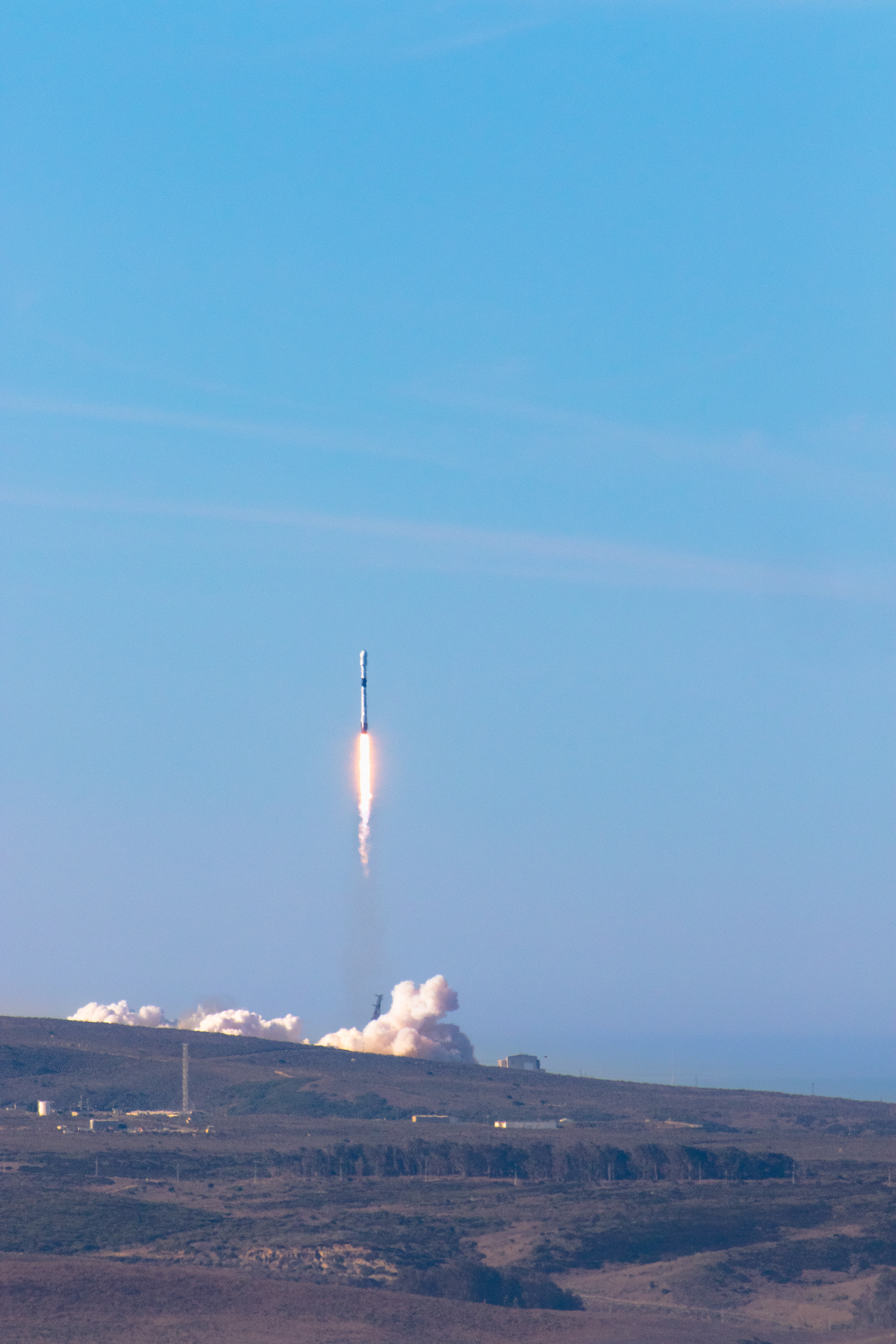 A SpaceX Falcon 9 rocket lifts up from Vandenberg AFB.
