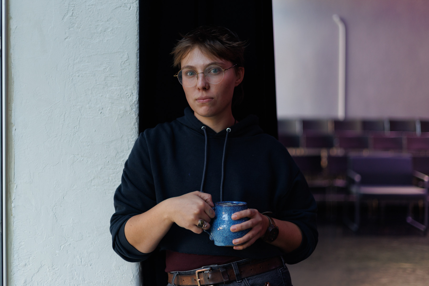 Mal MacKenzie poses for a portrait at KST’s Alloy Studios, Sept. 25. MacKenzie’s upcoming play “AURA” is about a mother who creates an AI chatbot to retain an artificial, cisgender version of her still-living child. (Photo by Danny Arensberg/Pittsburgh’s Public Source)
