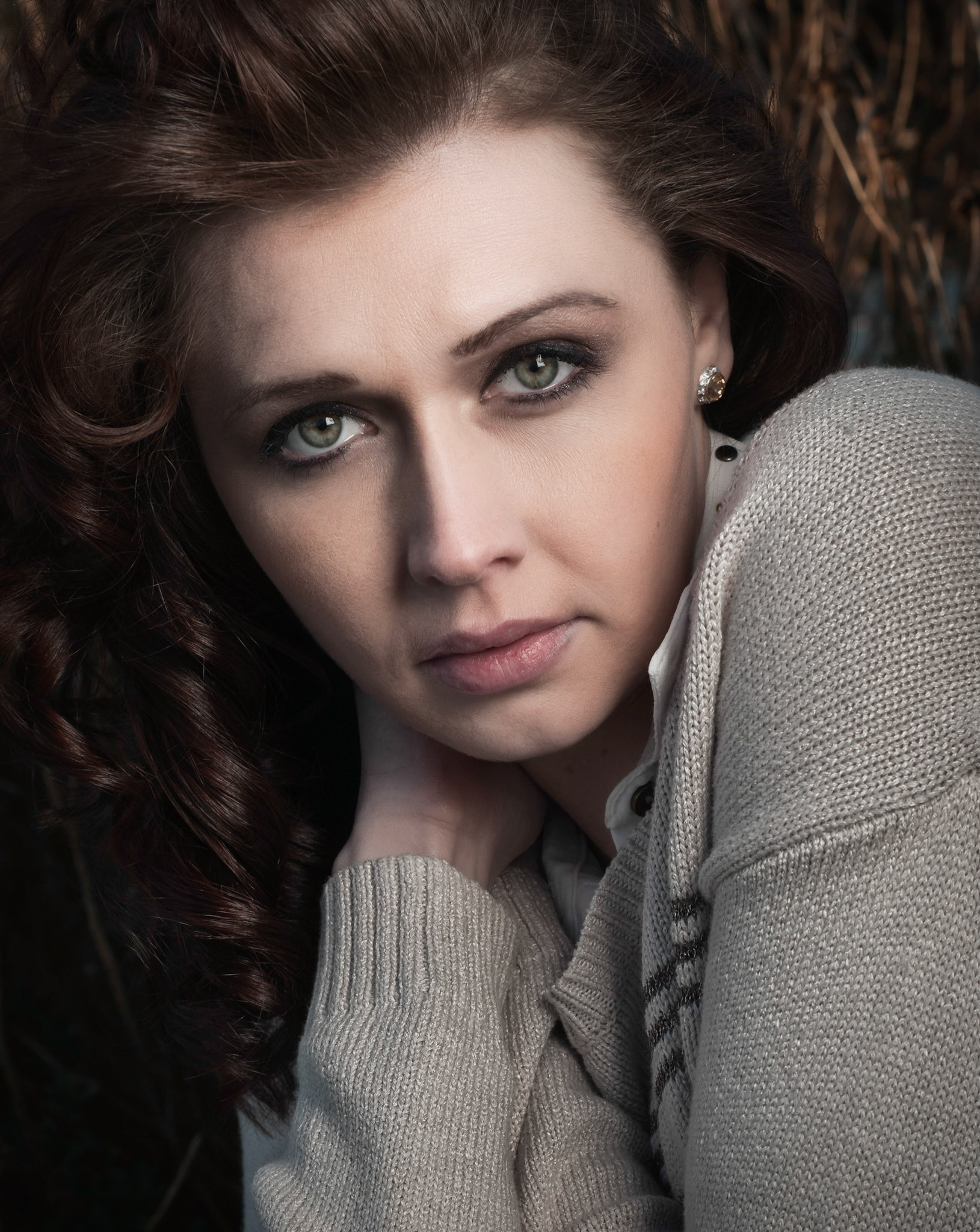 Shot this using one light - SB-910 on a lastolite hotshoe 24" softbox camera rightit was sunset time and she was standing in the shade but the sun was hitting the background which happens to be some branches of some kind of a plant.