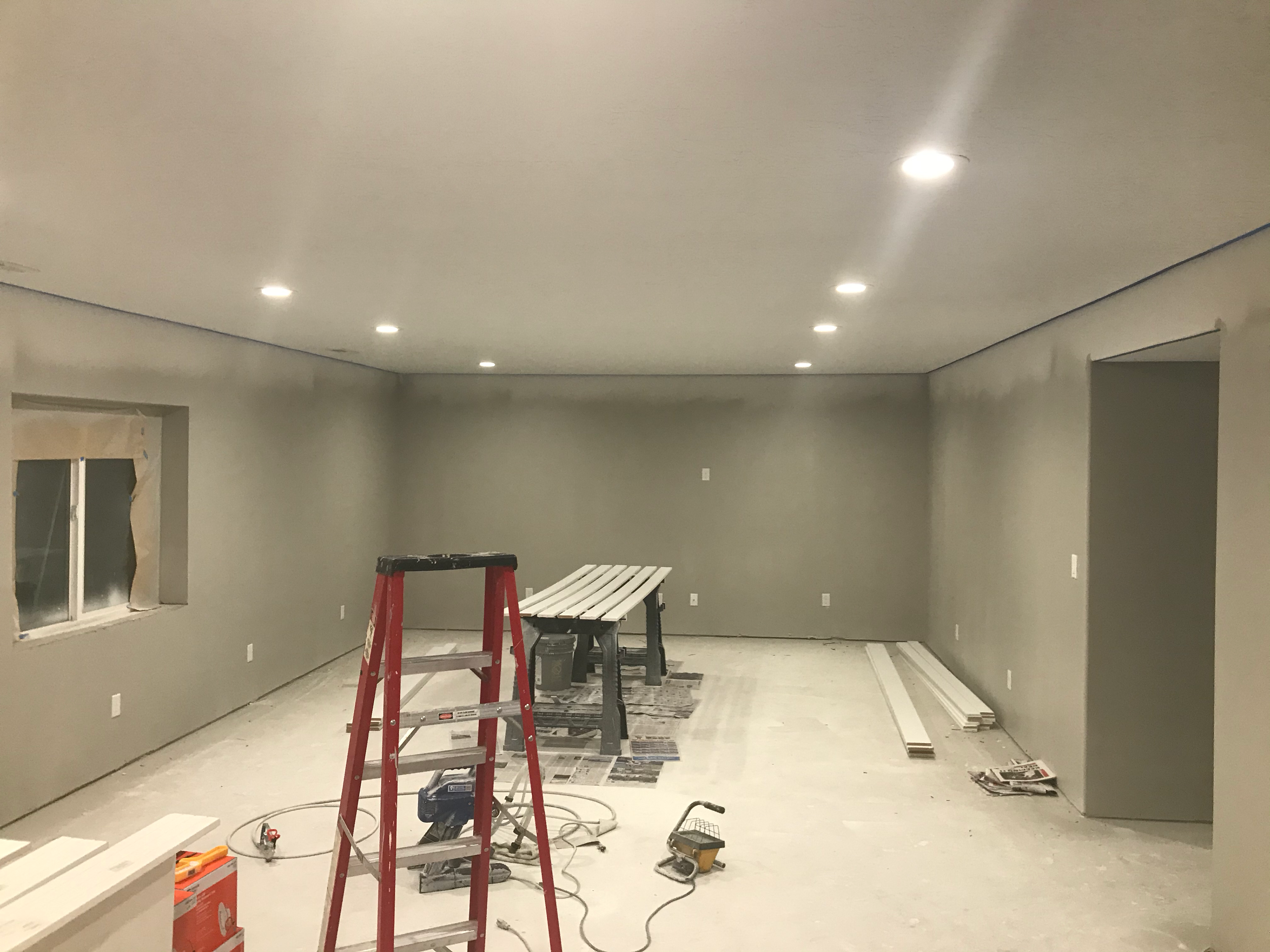 Unfinished basement before mural installation