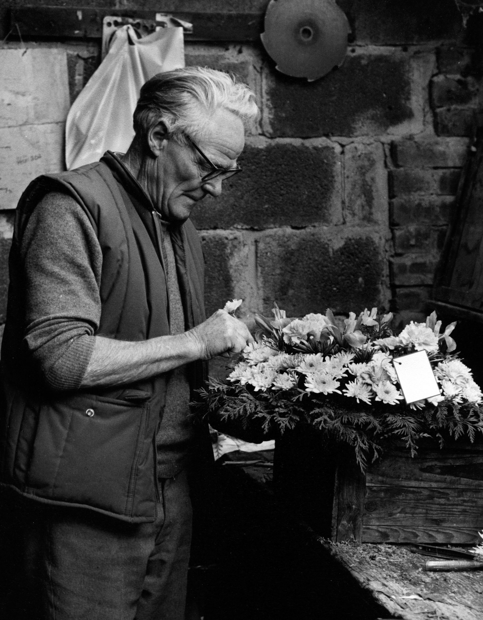 Salter and Son, 1984 florists, horticulturists and green grocers, Jack prepares a wreath.