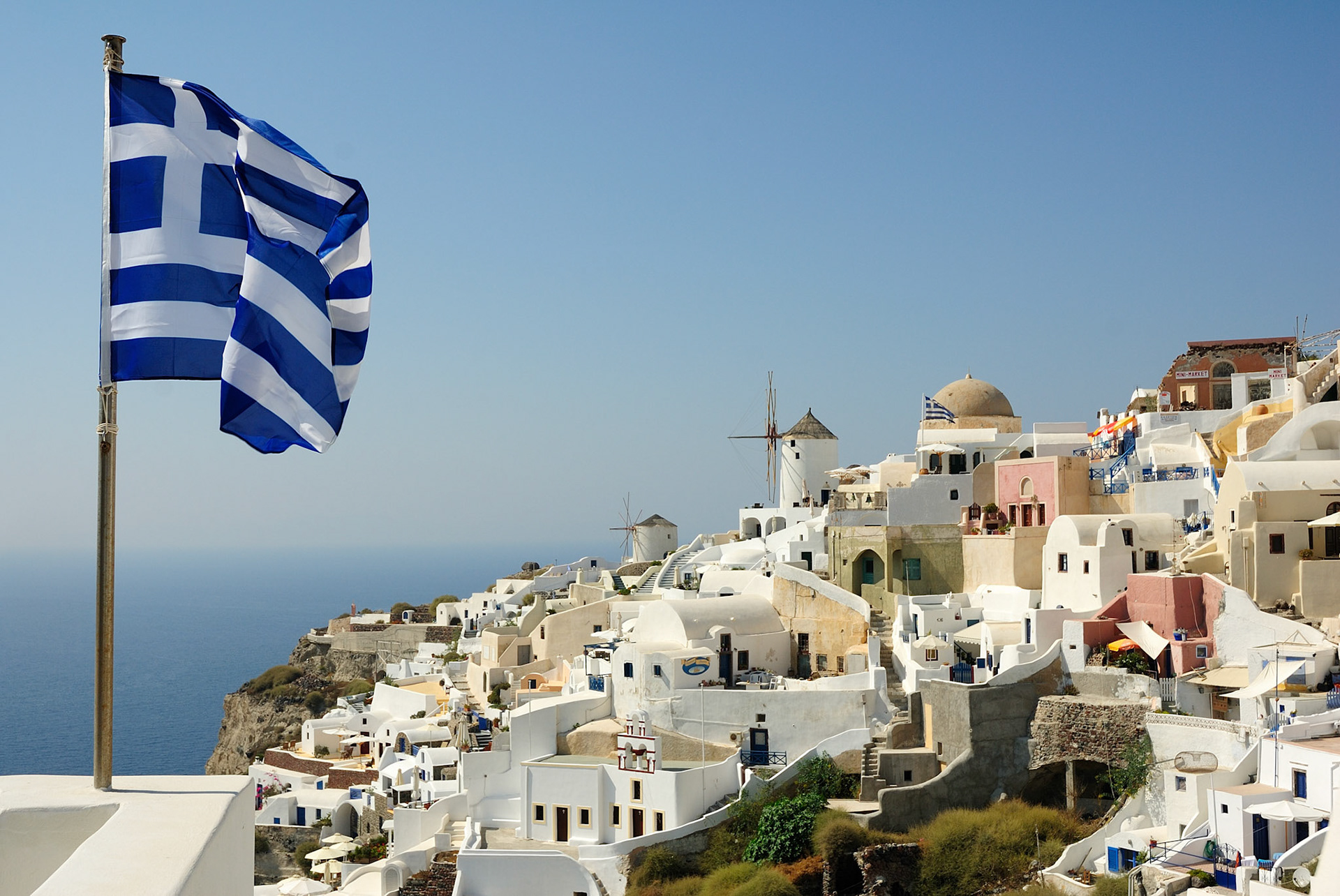 The flag and the Greek windmills - Santorini