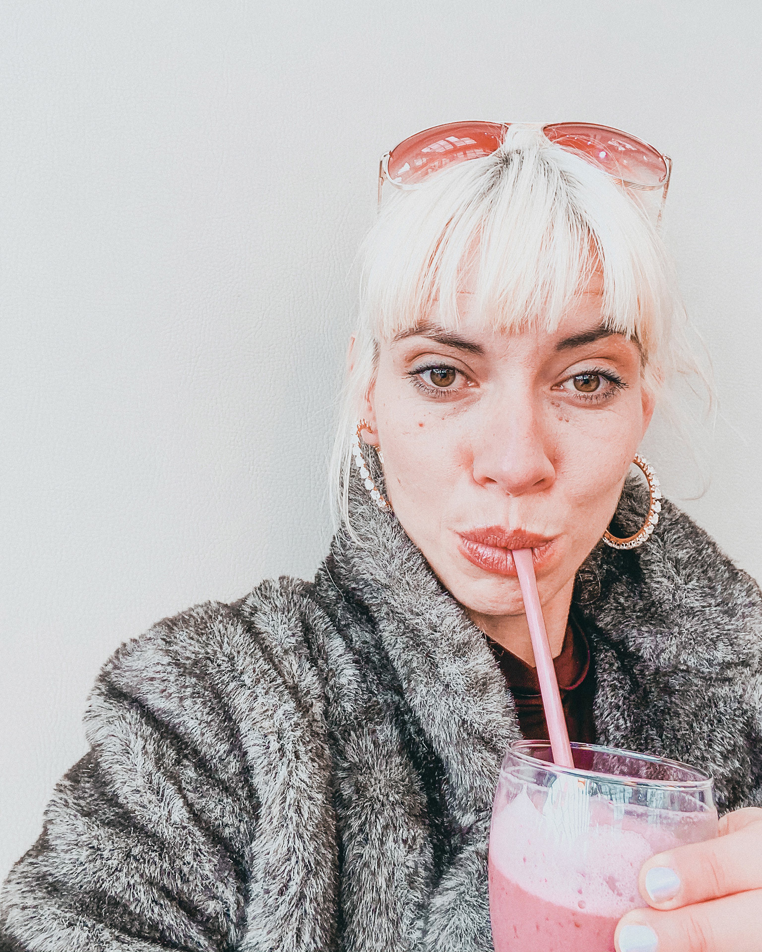 Ninoschka sipping on a pink milkshake