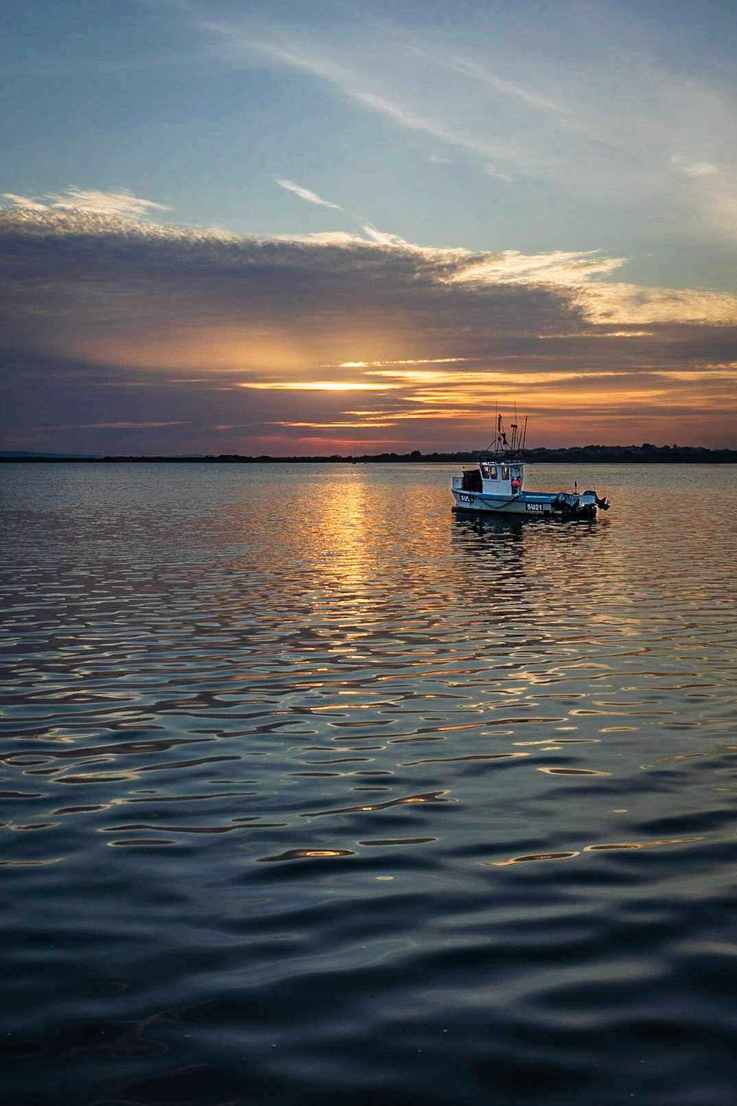 A Fishing Boat at Sunset at Mudeford Quay, Dorset, UK (UK046)