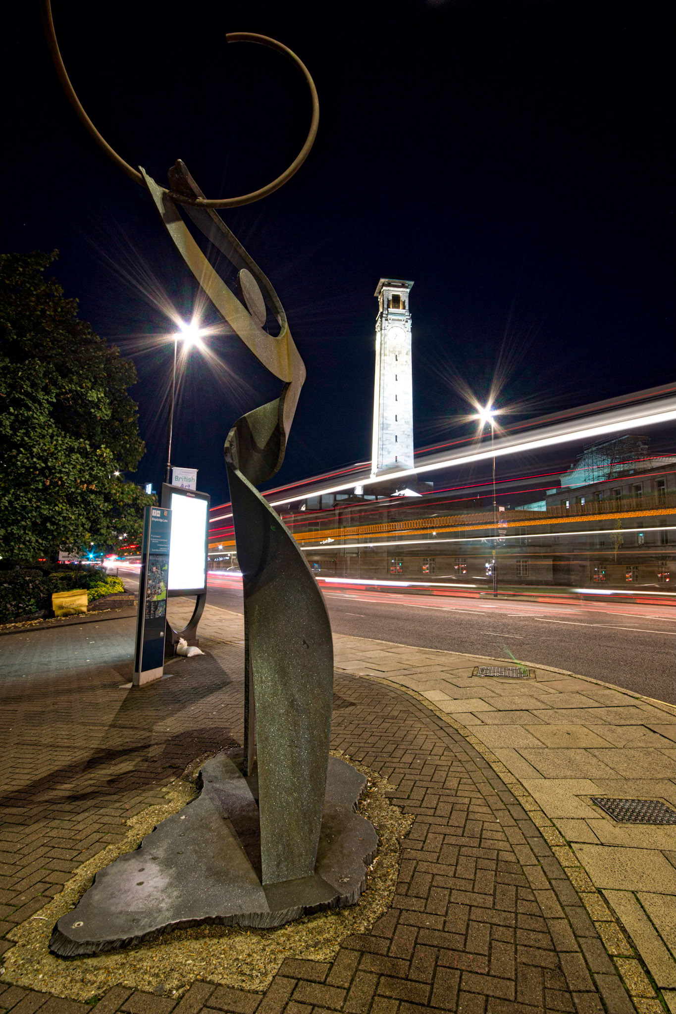 Night shot of buses passing the Civic Centre in Southampton, Hampshire, UK (HA038)