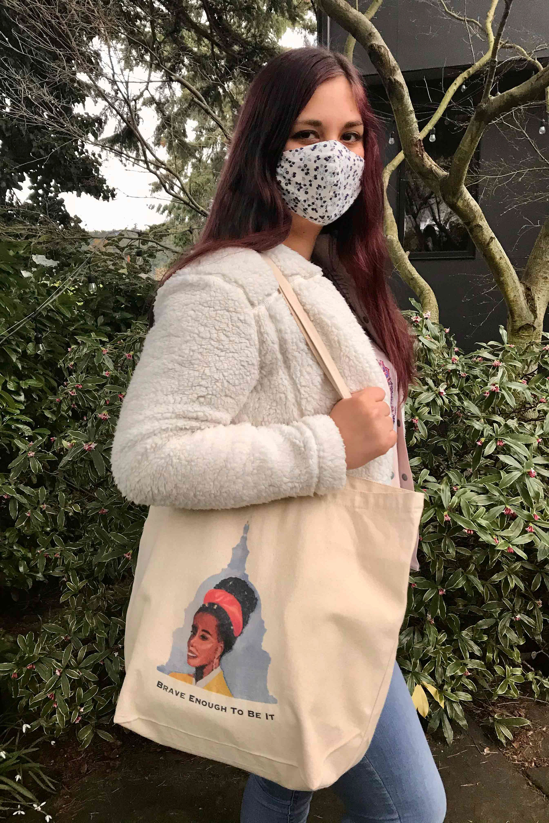 Woman holding Brave Enough Bag with painting of Amanda Gorman on it.