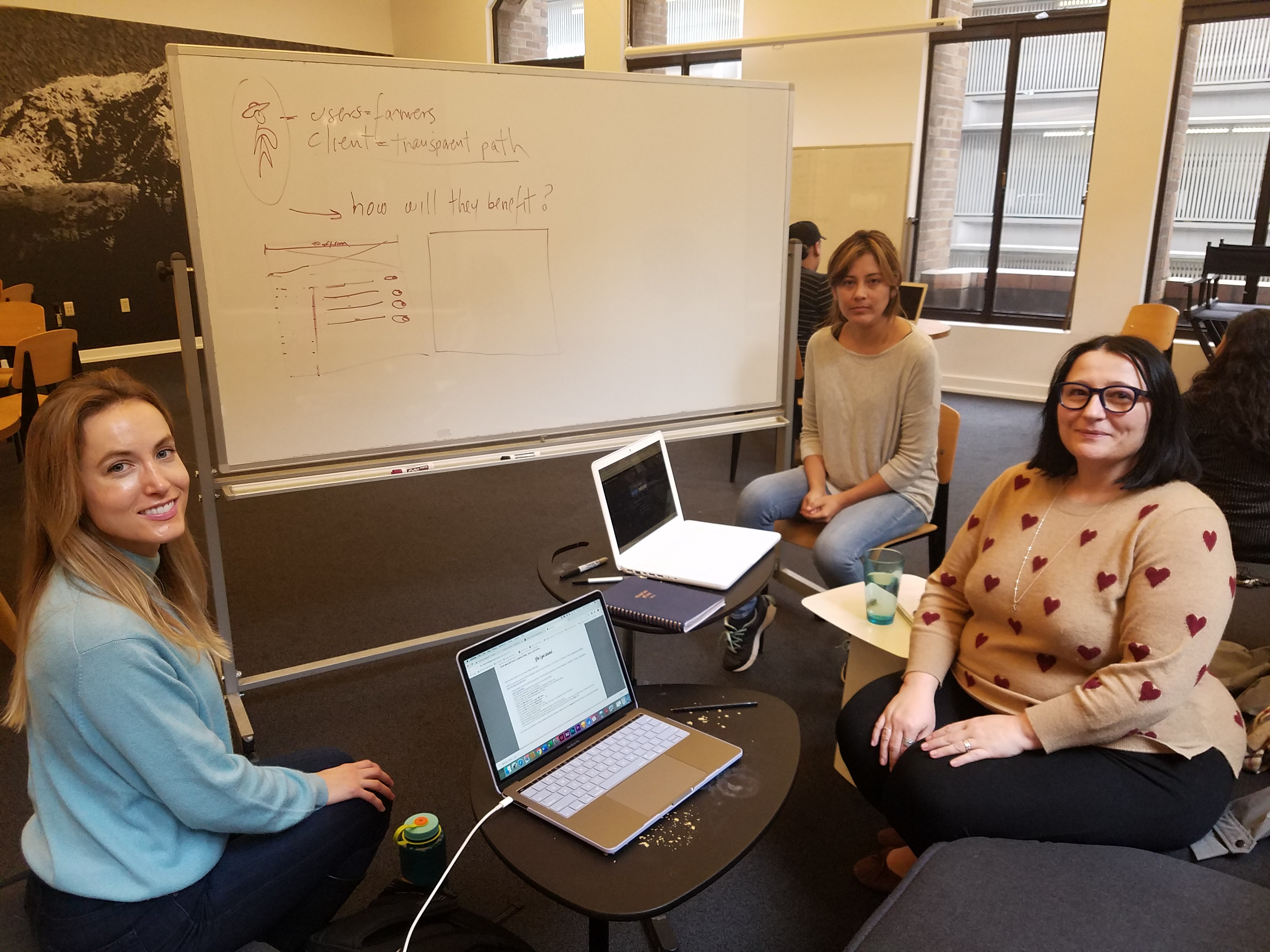 My teammates meet with a Transparent Path team member.  (Photographed by me.)